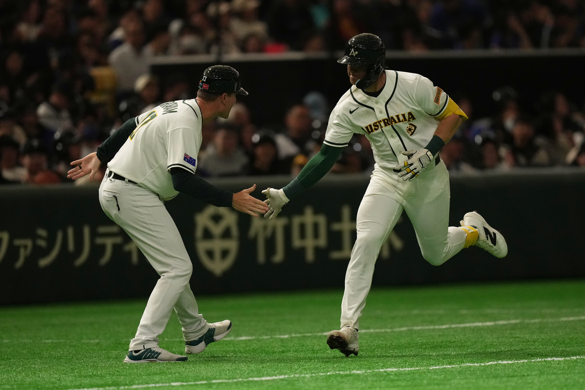 Australia's catcher Robbie Perkins celebrates after hits a two-run home run against Taiwan's pitcher Chen Po-yu in the fifth inning