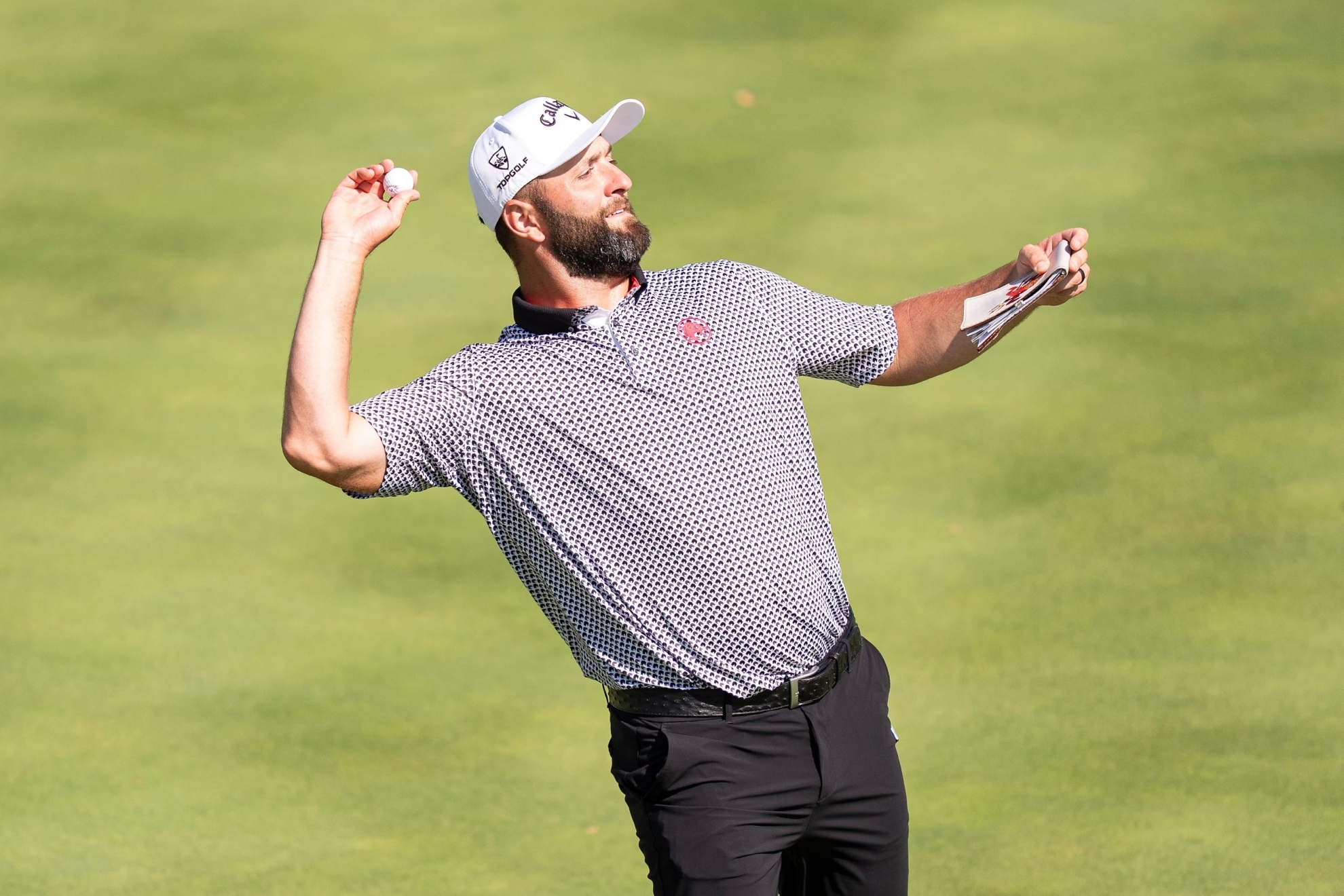 Captain Jon Rahm of Legion XIII throws a golf ball to the fans.