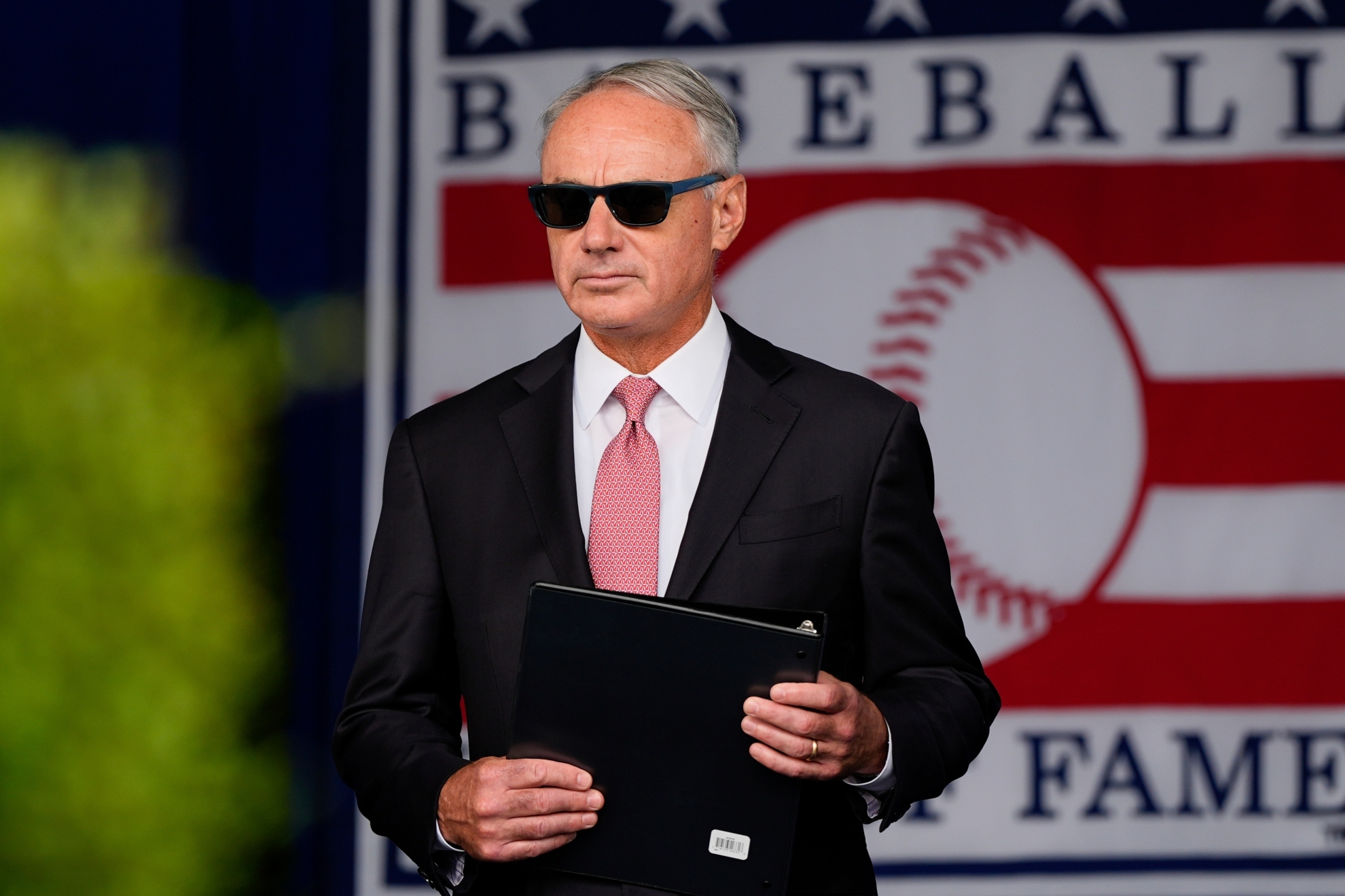 Major League Baseball Commissioner Rob Manfred arrives at the National Baseball Hall of Fame induction ceremony.