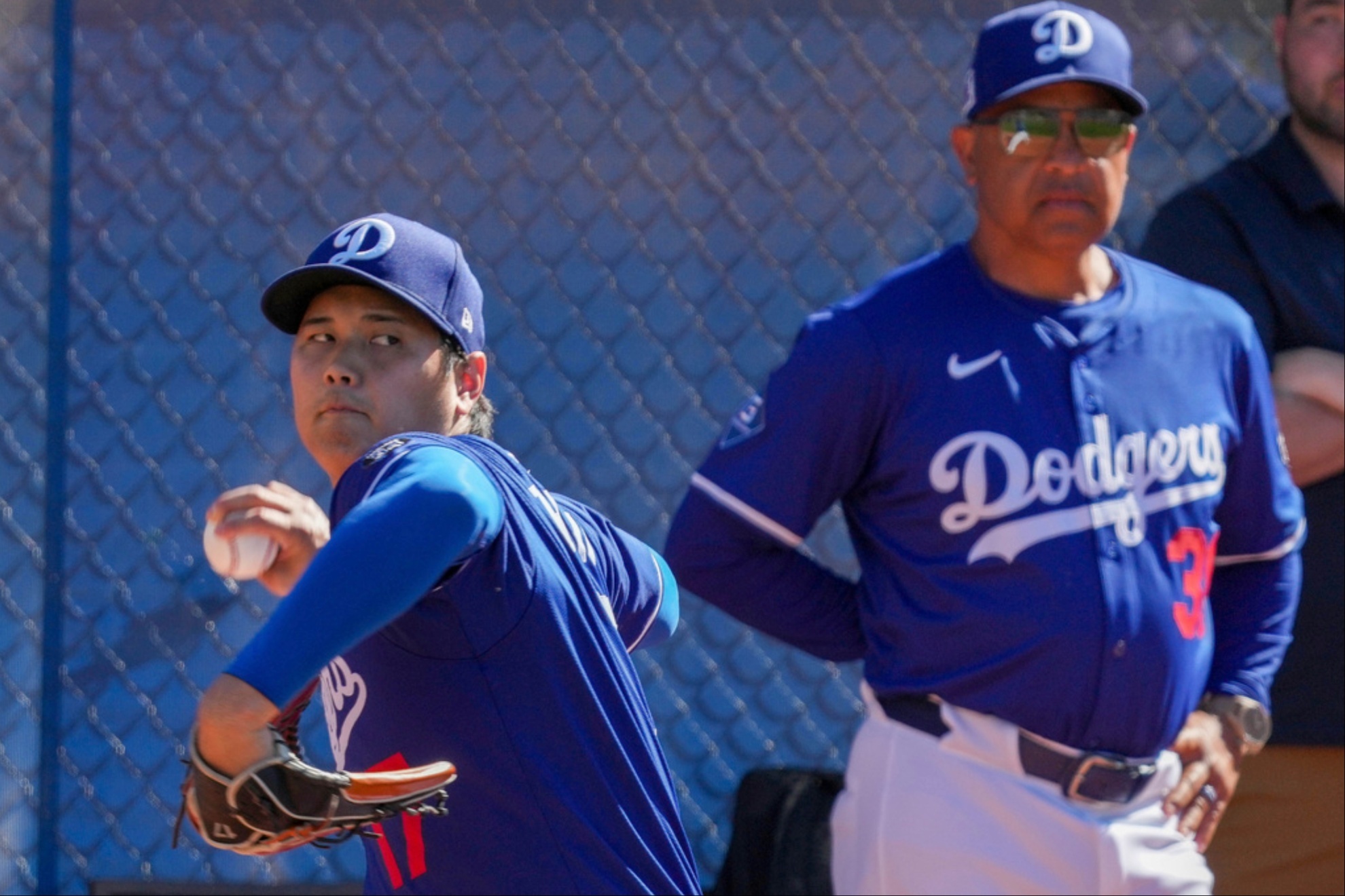 Dave Roberts (R) carefully monitors Shohei Ohtani's progress.