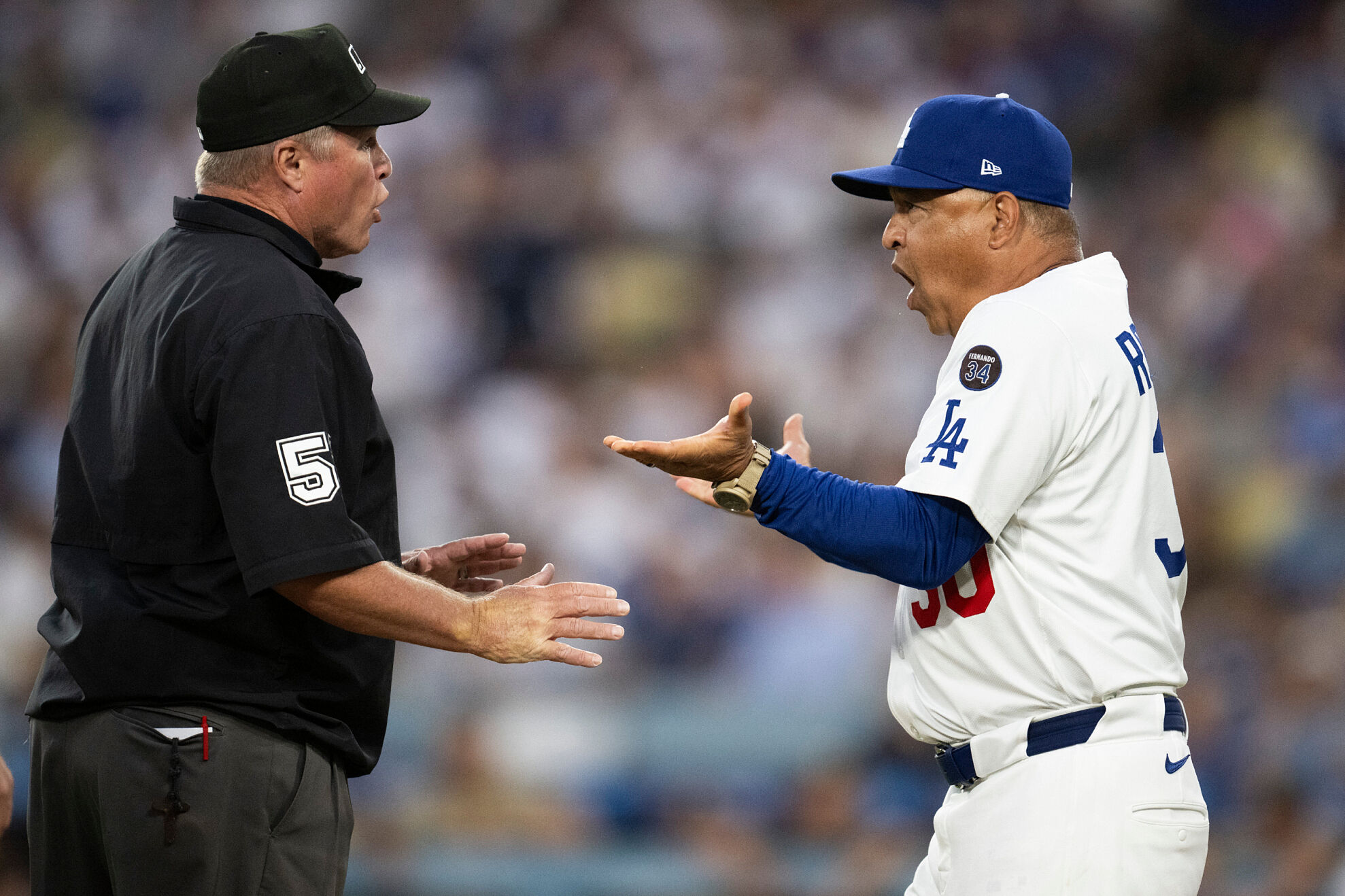 Los Angeles Dodgers manager Dave Roberts, right, argues with umpire Marvin Hudson after getting ejected during the third inning of a baseball game against the San Diego Padres in Los Angeles, Tuesday, June 17, 2025.
