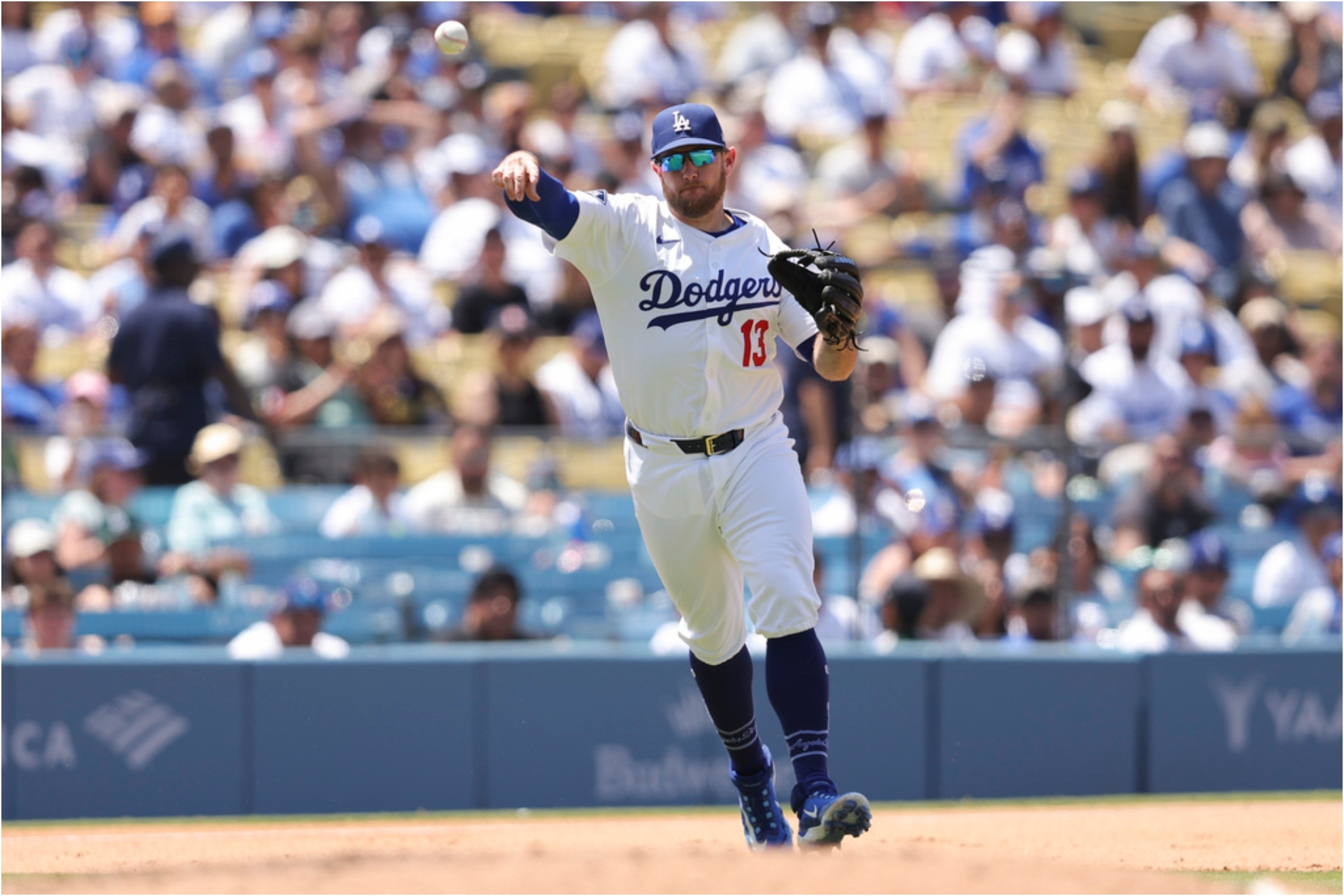 Los Angeles Dodgers third baseman Max Muncy (13) throws to first base.
