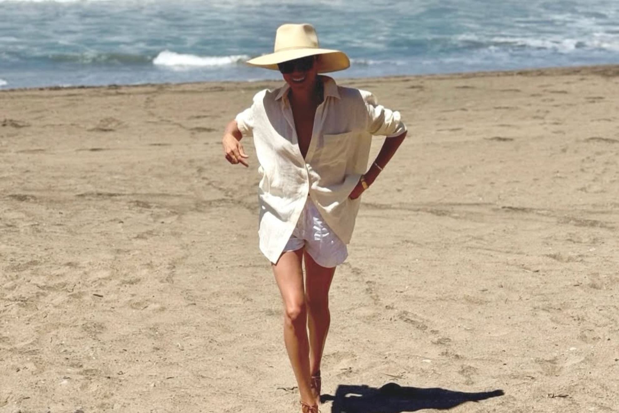 meghan markle enjoys the beach in a flowing white dress Meghan Markle posts glam beach photo amid royal no-show