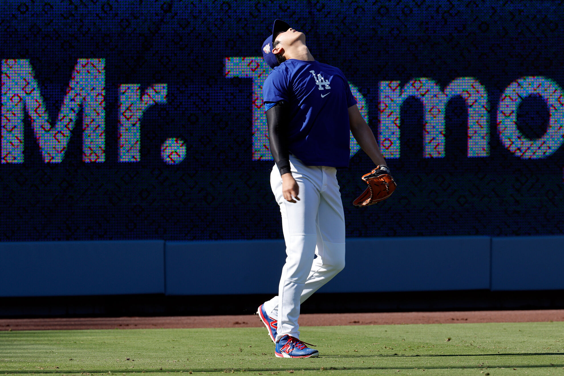 Los Angeles Dodgers two-way player Shohei Ohtani reacts as he throws pitches in the outfield before a baseball game against the Chicago White Sox, Wednesday, July 2, 2025, in Los Angeles.