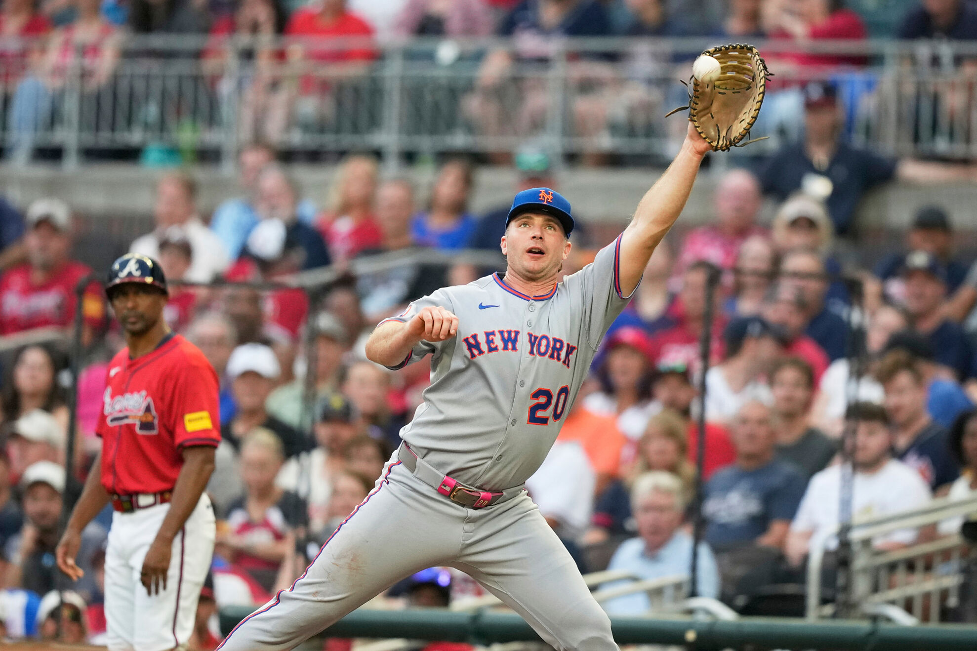 New York Mets first base Pete Alonso (20) tags out Atlanta Braves designated hitter Marcell Ozuna (20) in the second inning of a baseball game, Friday, Aug. 22, 2025, in Atlanta.