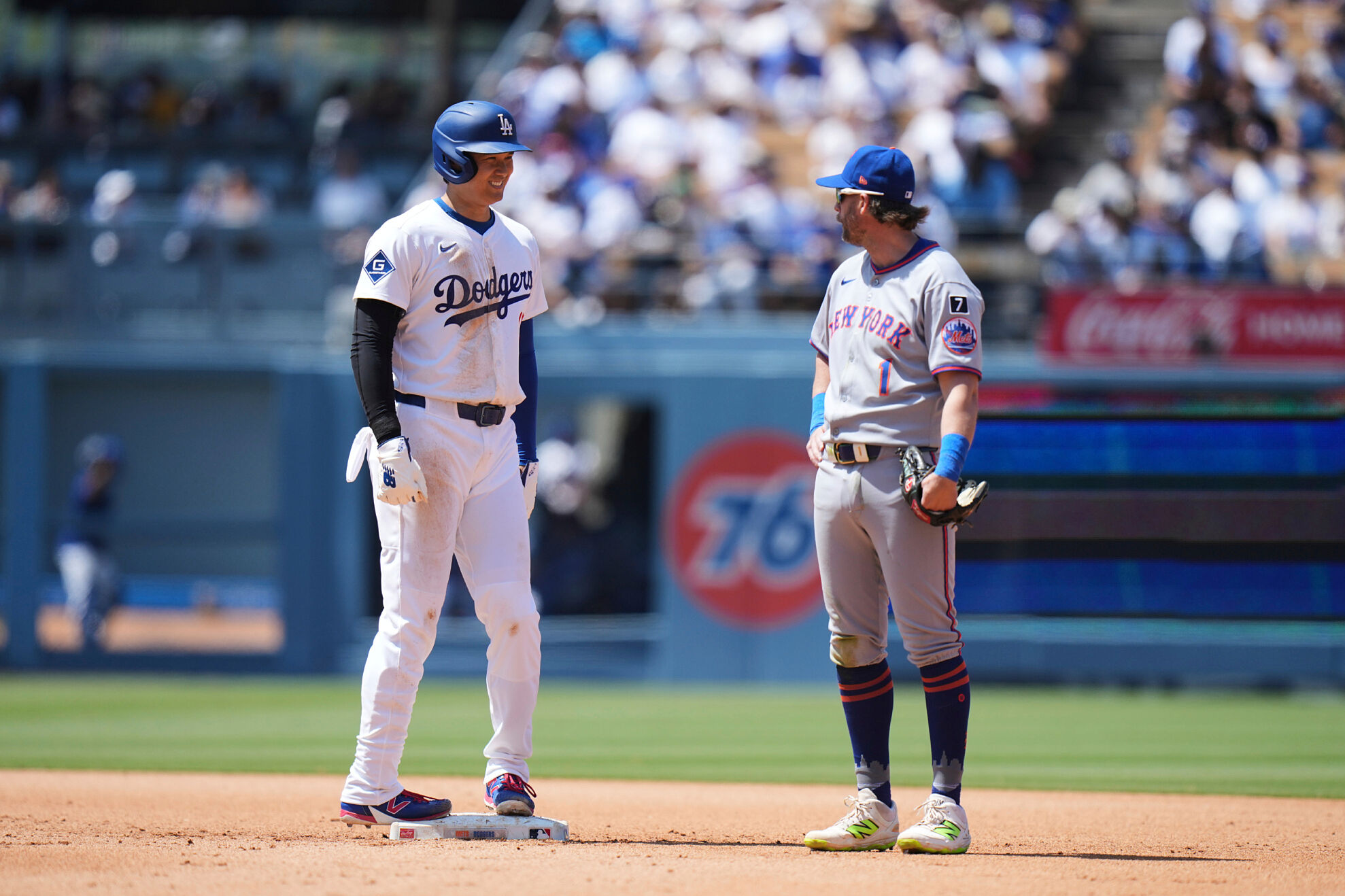 Los Angeles Dodgers' Shohei Ohtani (17) chats with New York Mets second base Jeff McNeil (1) during the fifth inning of a baseball game Thursday, June 5, 2025, in Los Angeles.