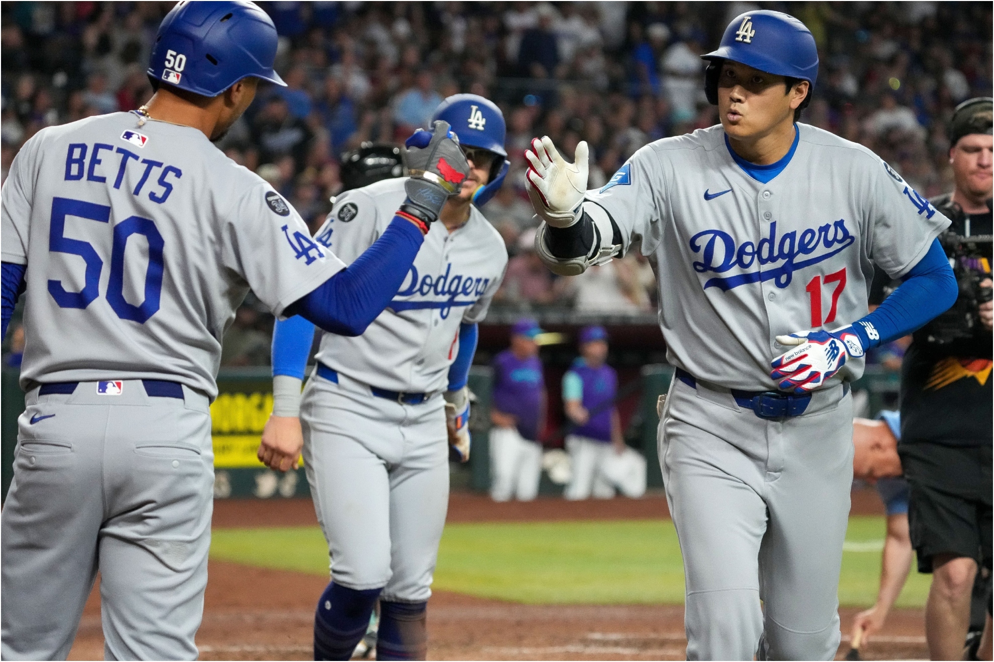 Los Angeles Dodgers' Shohei Ohtani, right, gets a high five from Mookie Betts.