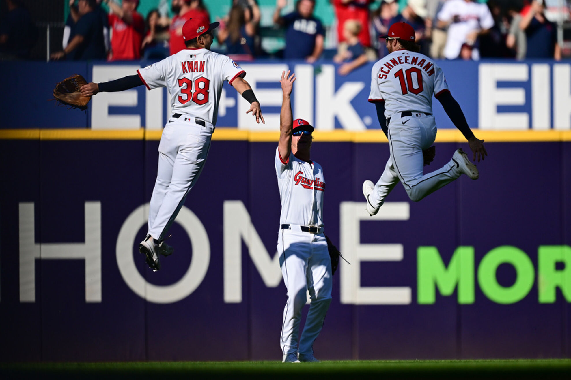 From left, Cleveland Guardians' Steven Kwan, Petey Halpin and Daniel Schneemann celebrate after winning Game 2 of the American League Wild Card baseball playoff series against the Detroit Tigers in Cleveland, Wednesday, Oct. 1, 2025.