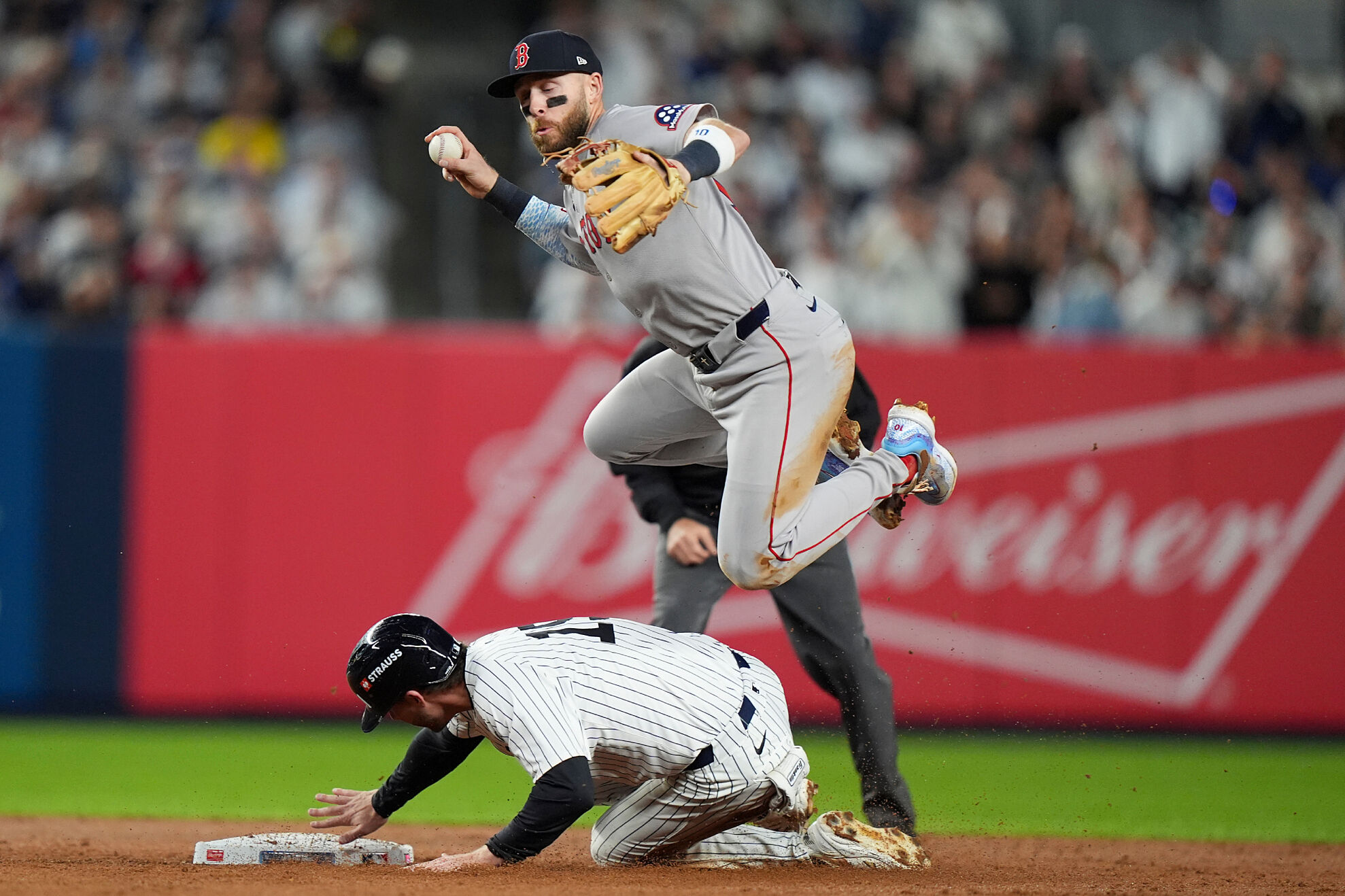 Boston Red Sox shortstop Trevor Story can't make the throw to first as New York Yankees third base Ryan McMahon (19) slides into second base during the third inning of Game 2 of an American League wild-card baseball playoff series, Wednesday, Oct. 1, 2025, in New York.