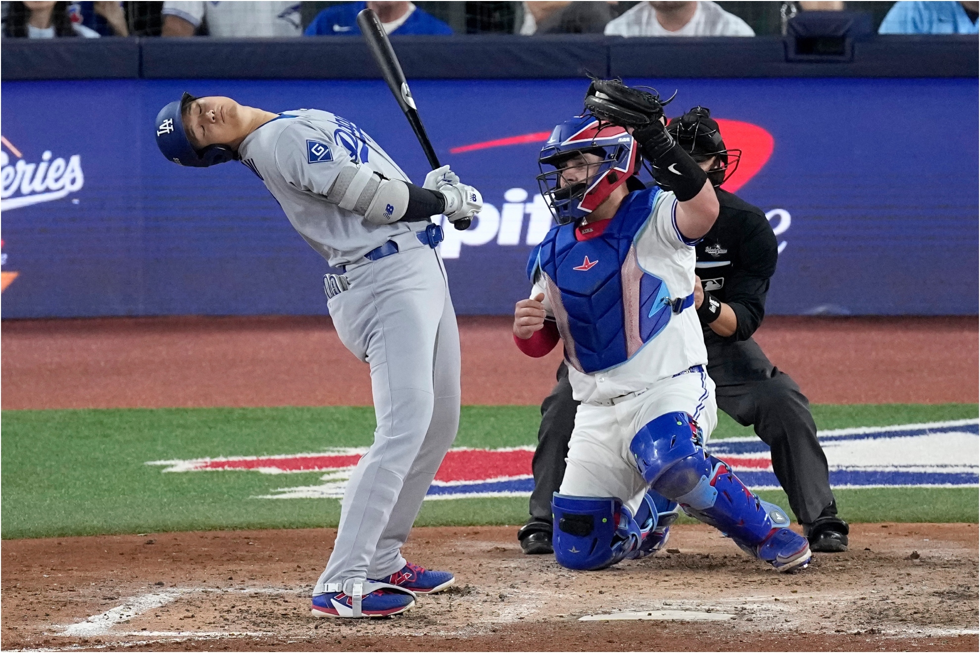 Shohei Ohtani leans away from an inside pitch as Toronto Blue Jays' Alejandro Kirk.