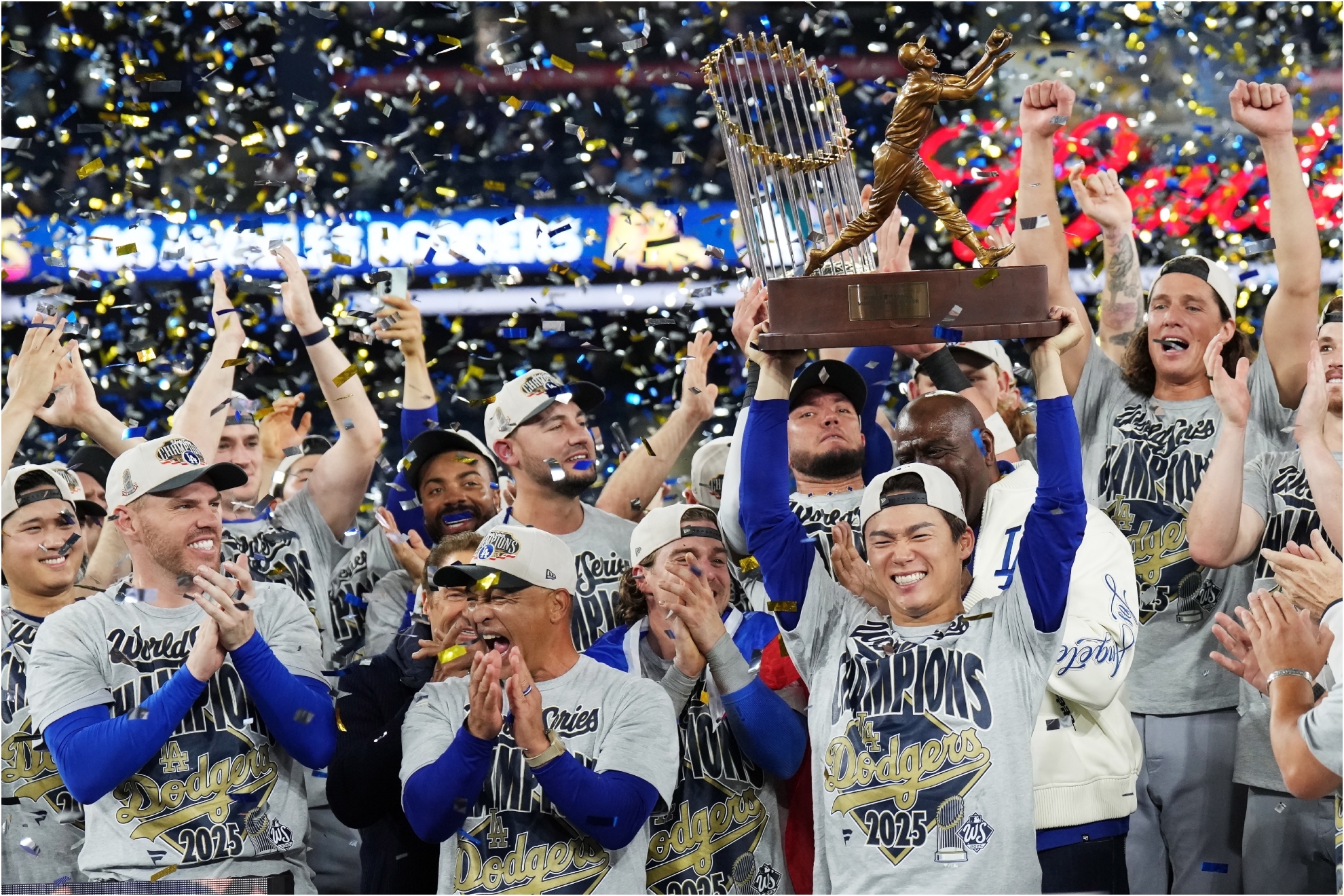 Los Angeles Dodgers pitcher Yamamoto, center right, lifts the World Series MVP trophy as the Dodgers celebrate.