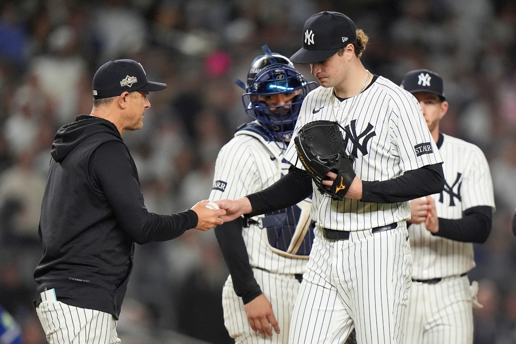 Manager Aaron Boone (L) is waiting to see what moves the New York Yankees front office will make in free agency.