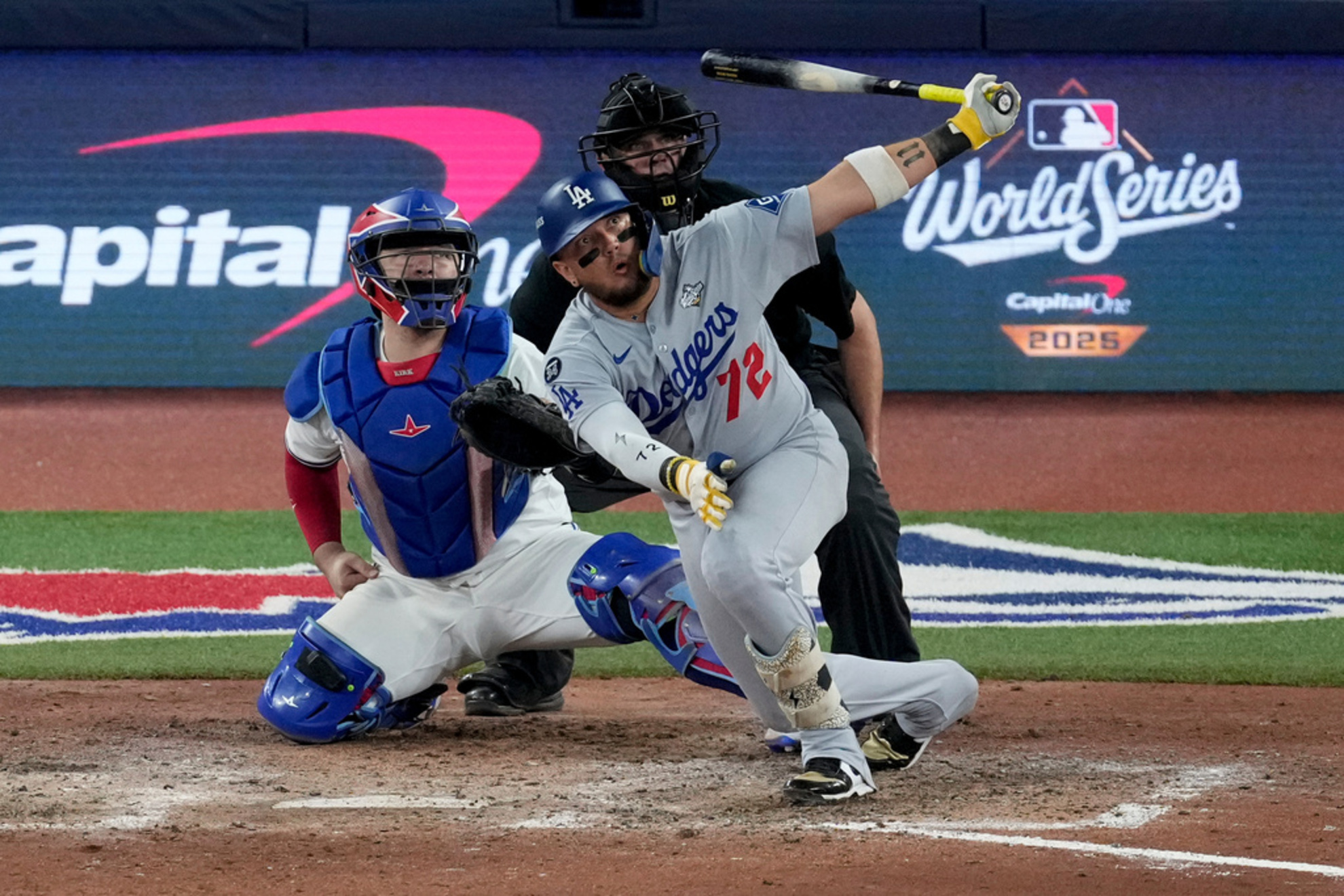 Los Angeles Dodgers' Miguel Rojas follows through on a home run