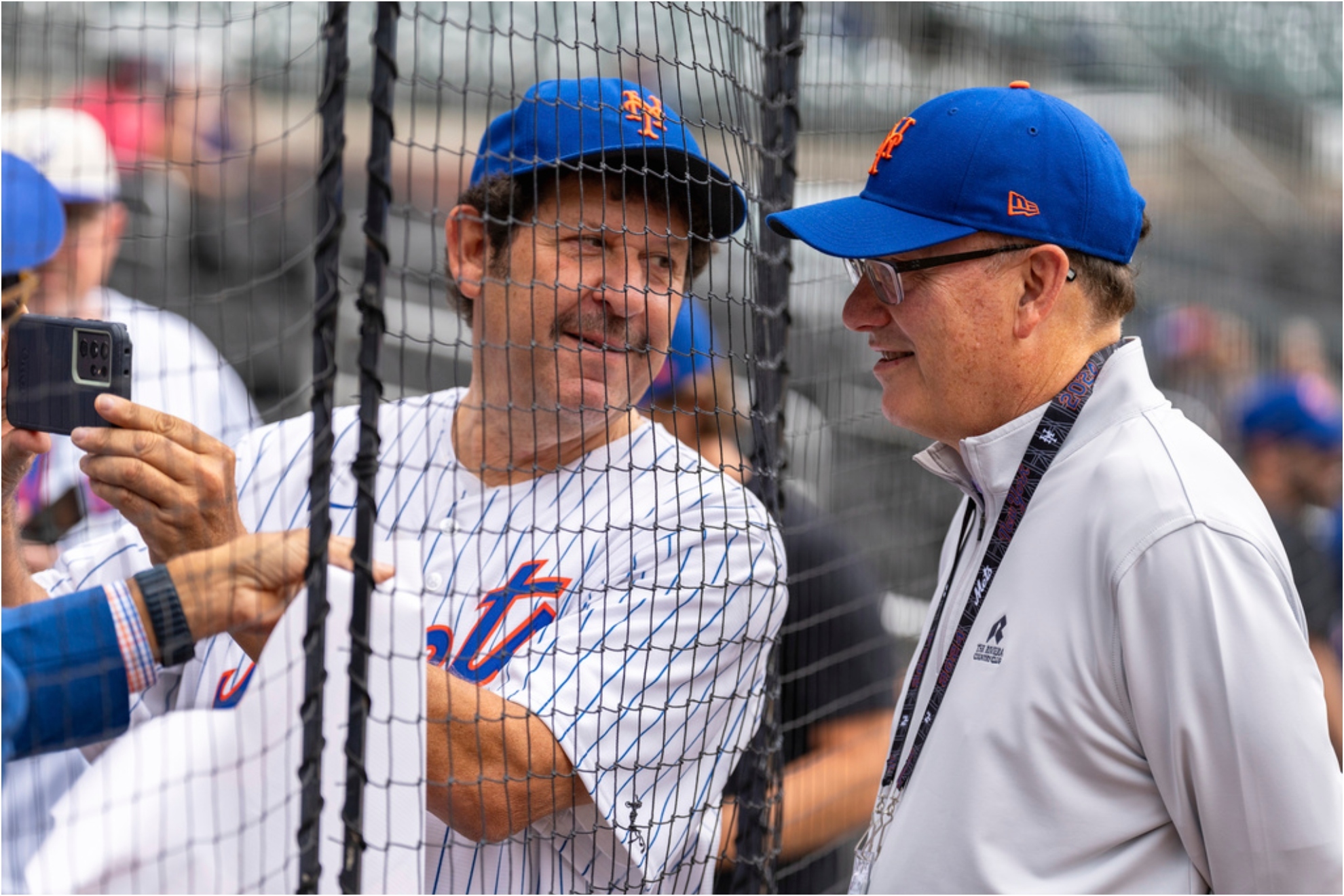 New York Mets owner Steve Cohen, right, poses with a fan for a photo.