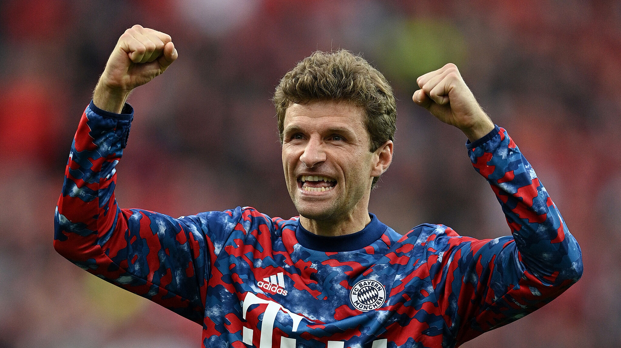 Thomas Muller celebrates in a Bayern Munich jumper after a match this season.