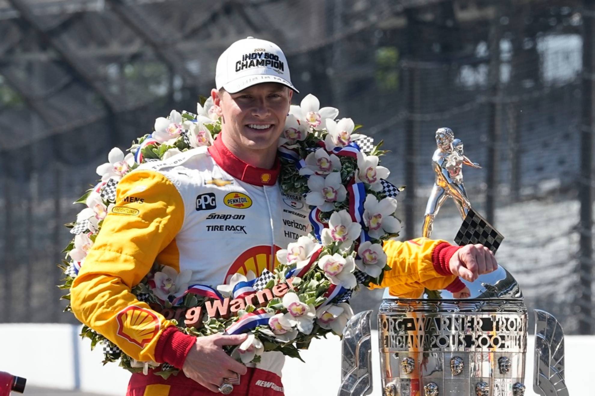 Josef Newgarden poses with the Borg-Warner Trophy during the traditional winners photo session at Indianapolis Motor Speedway /