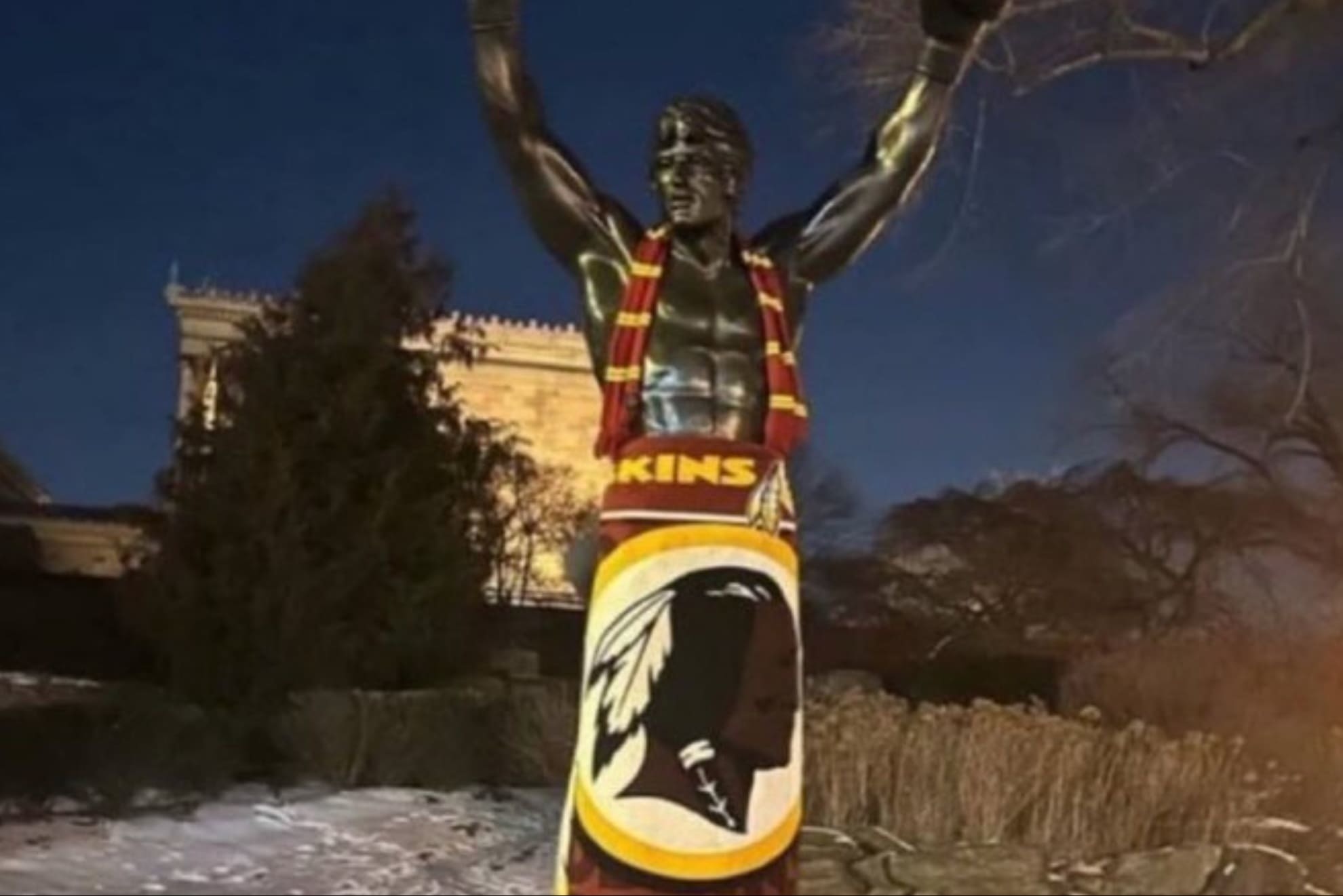 The Rocky statue in Philadelphia, with Washington Redskins/Commanders gear.
