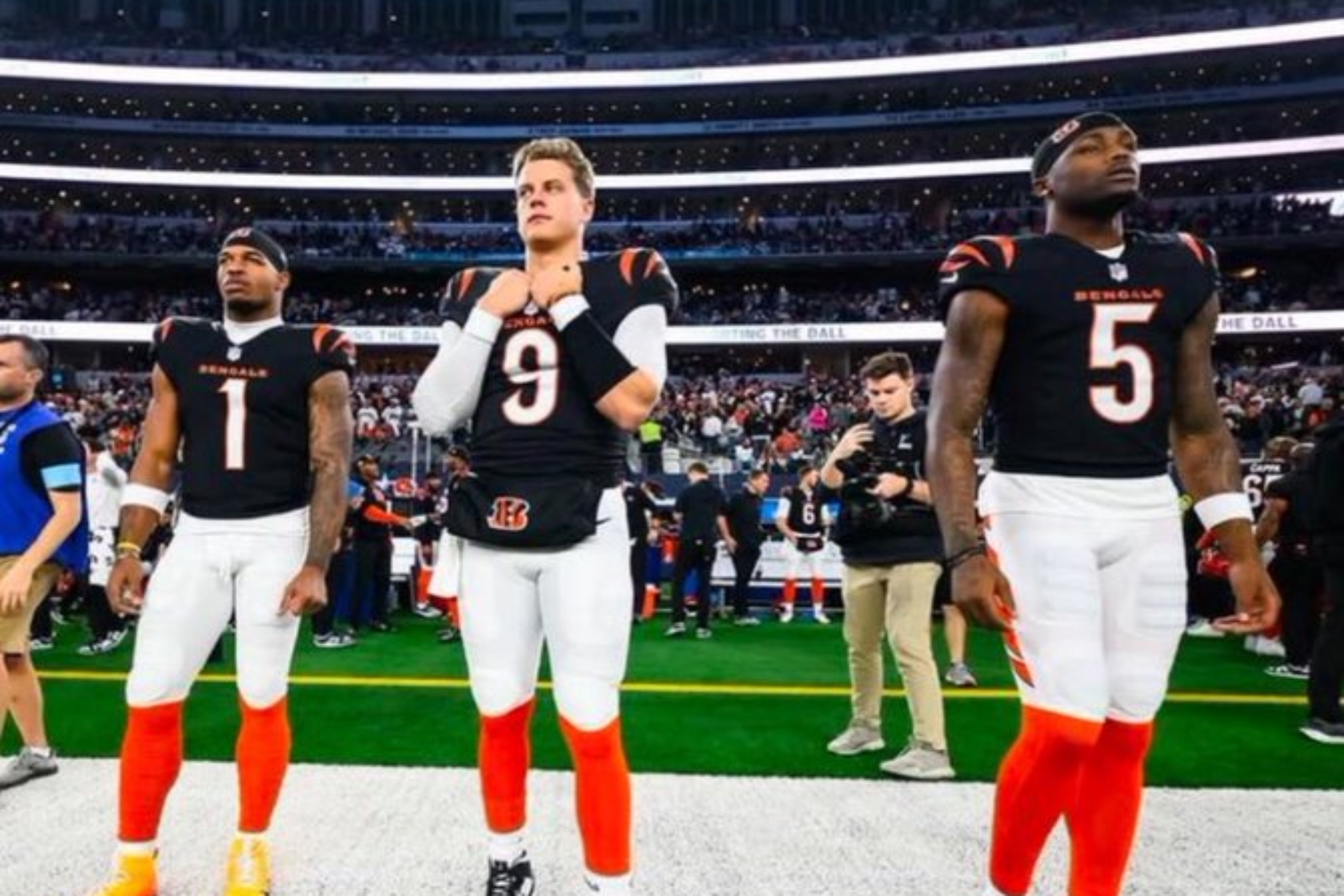 Ja'Marr Chase, Joe Burrow and Tee Higgins on the bench during an NFL game.