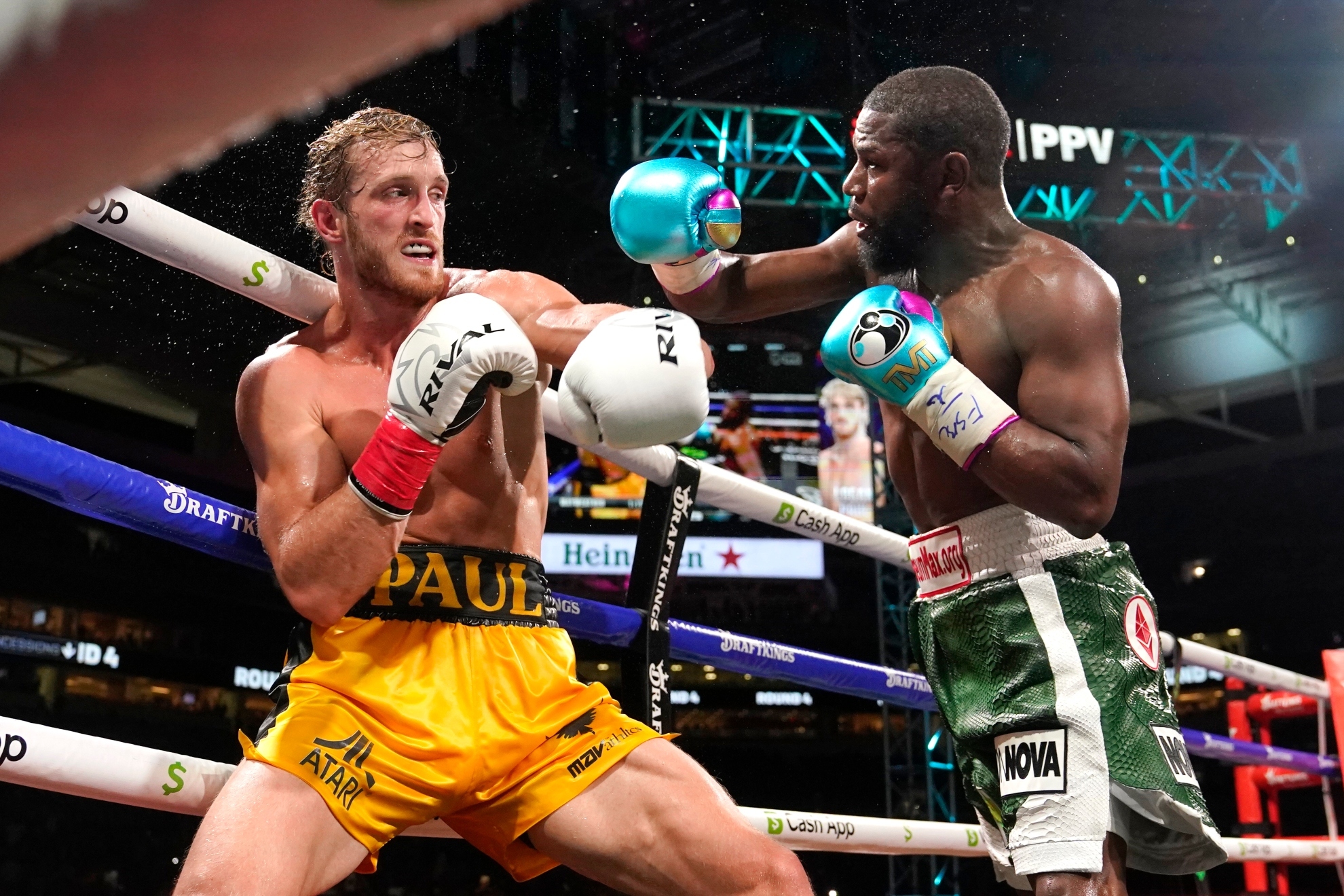 Logan Paul and Floyd Mayweather fight during an exhibition boxing match at Hard Rock Stadium in 2021.