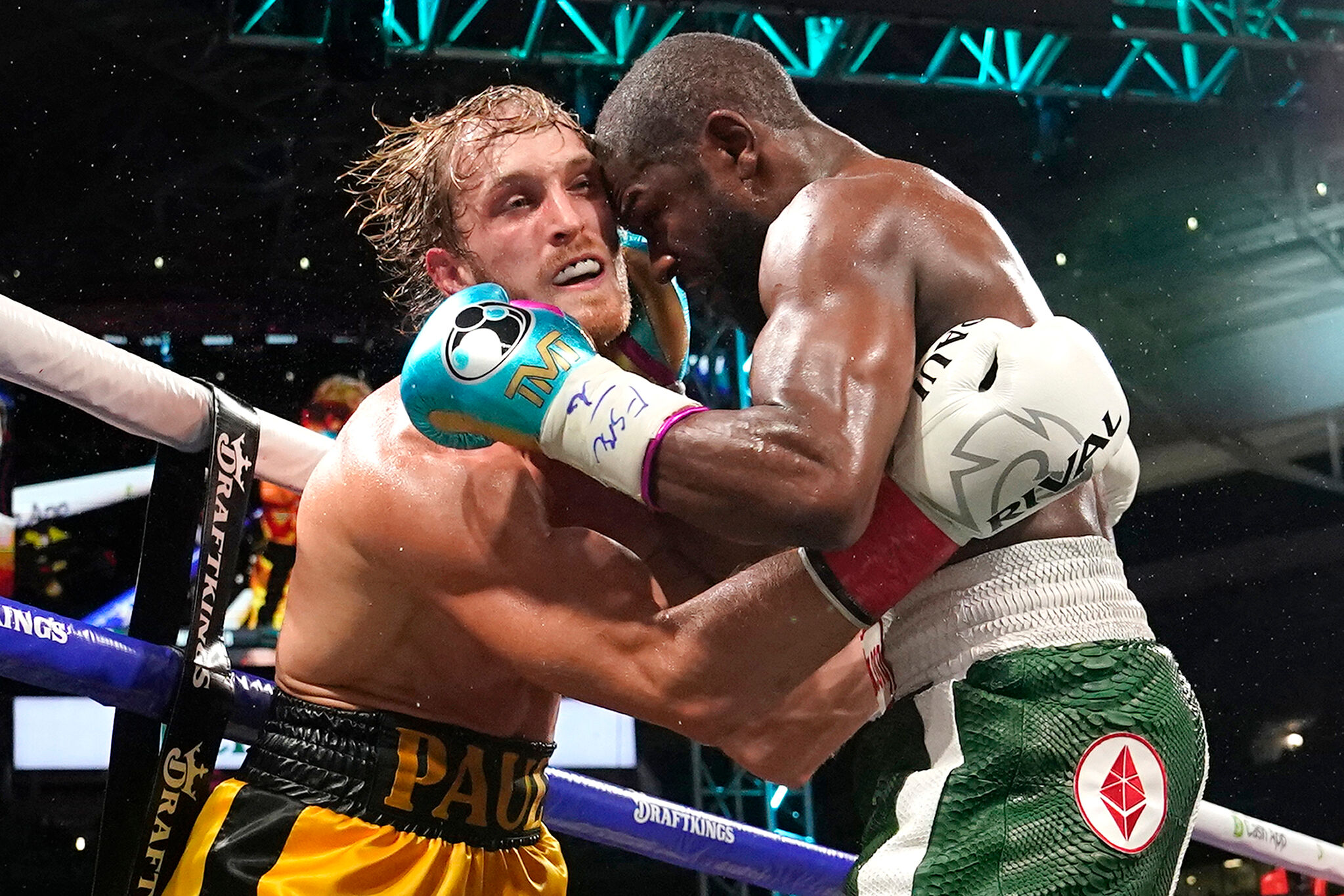 Logan Paul, left, and Floyd Mayweather fight during an exhibition boxing match at Hard Rock Stadium