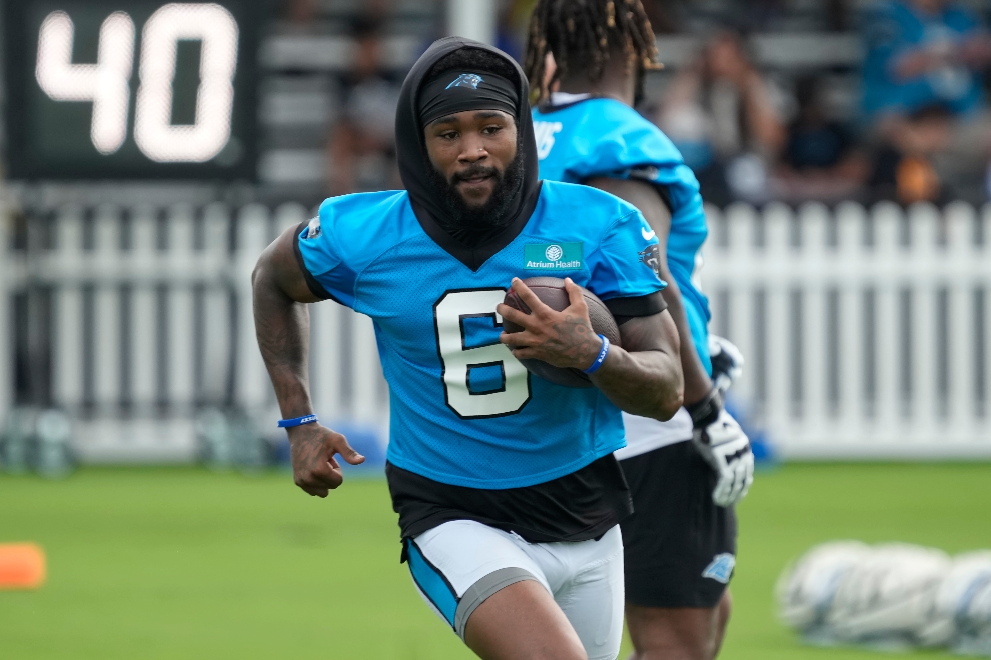 Carolina Panthers running back Miles Sanders runs a drill during the NFL football team's training camp in Charlotte, N.C., Wednesday, July 24, 2024.