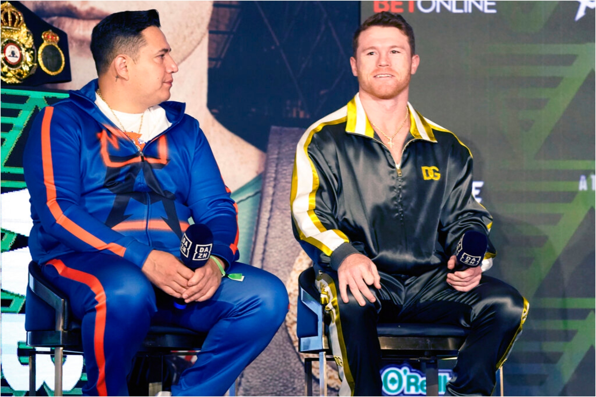 Boxers Canelo Alvarez of Mexico, right, smiles as he sits with trainer Eddy Reynoso.