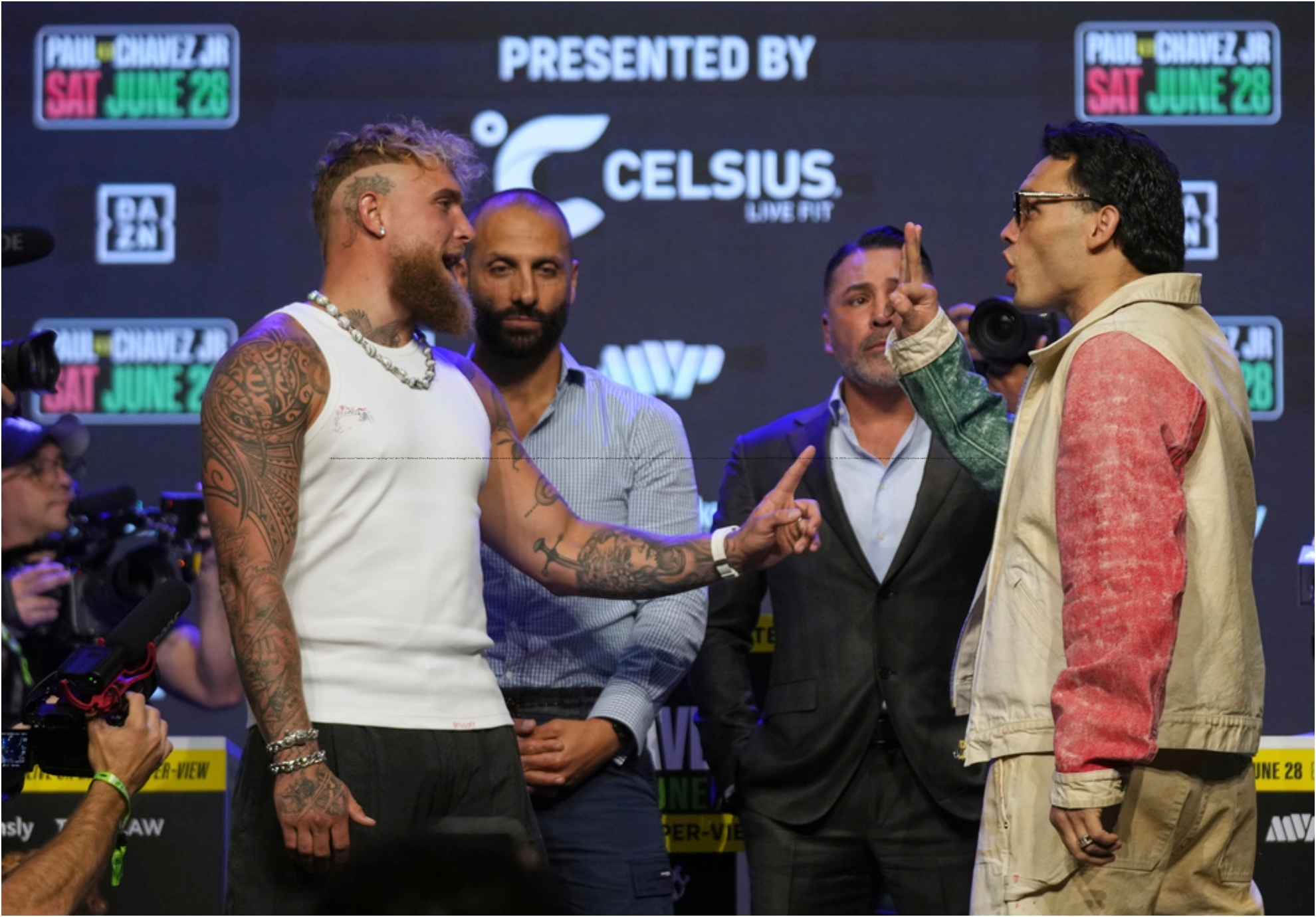 Boxers Jake Paul, left, gestures towards Julio Cesar Chavez Jr., Mexico's former world champion.