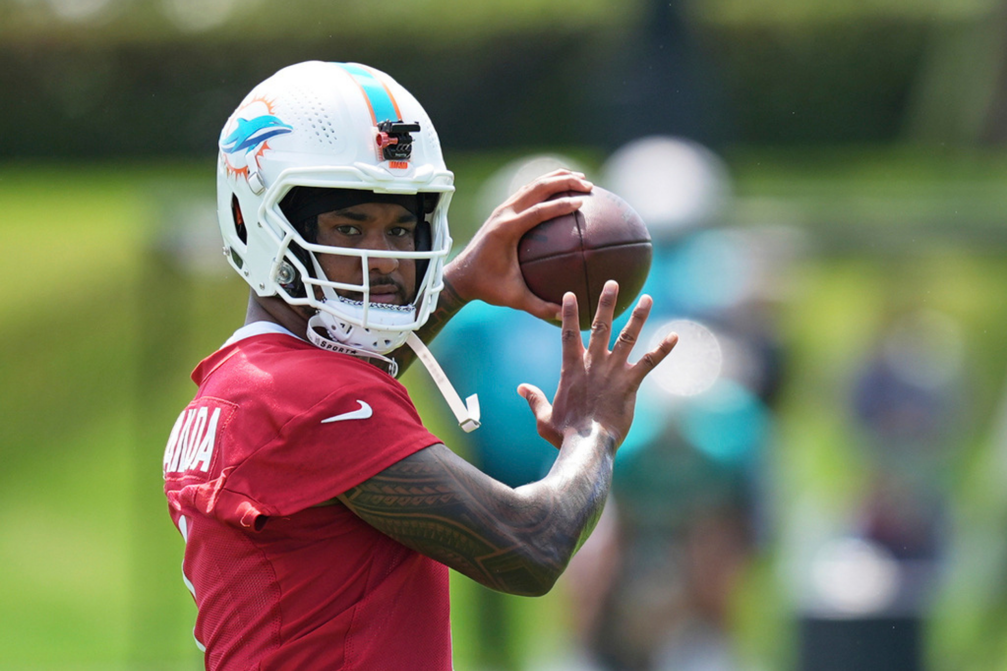 Miami Dolphins quarterback Tua Tagovailoa lines up a pass