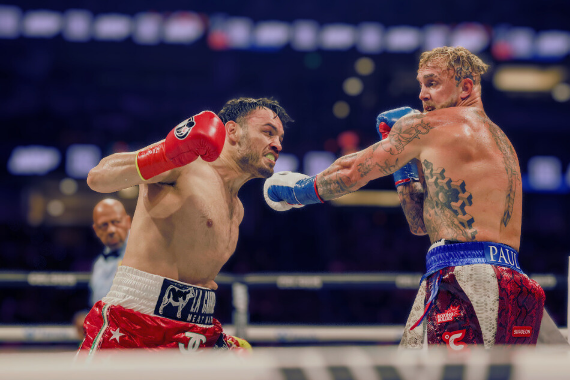 Julio Cesar Chavez Jr., left, throws a punch at Jake Paul during their cruiserweight boxing