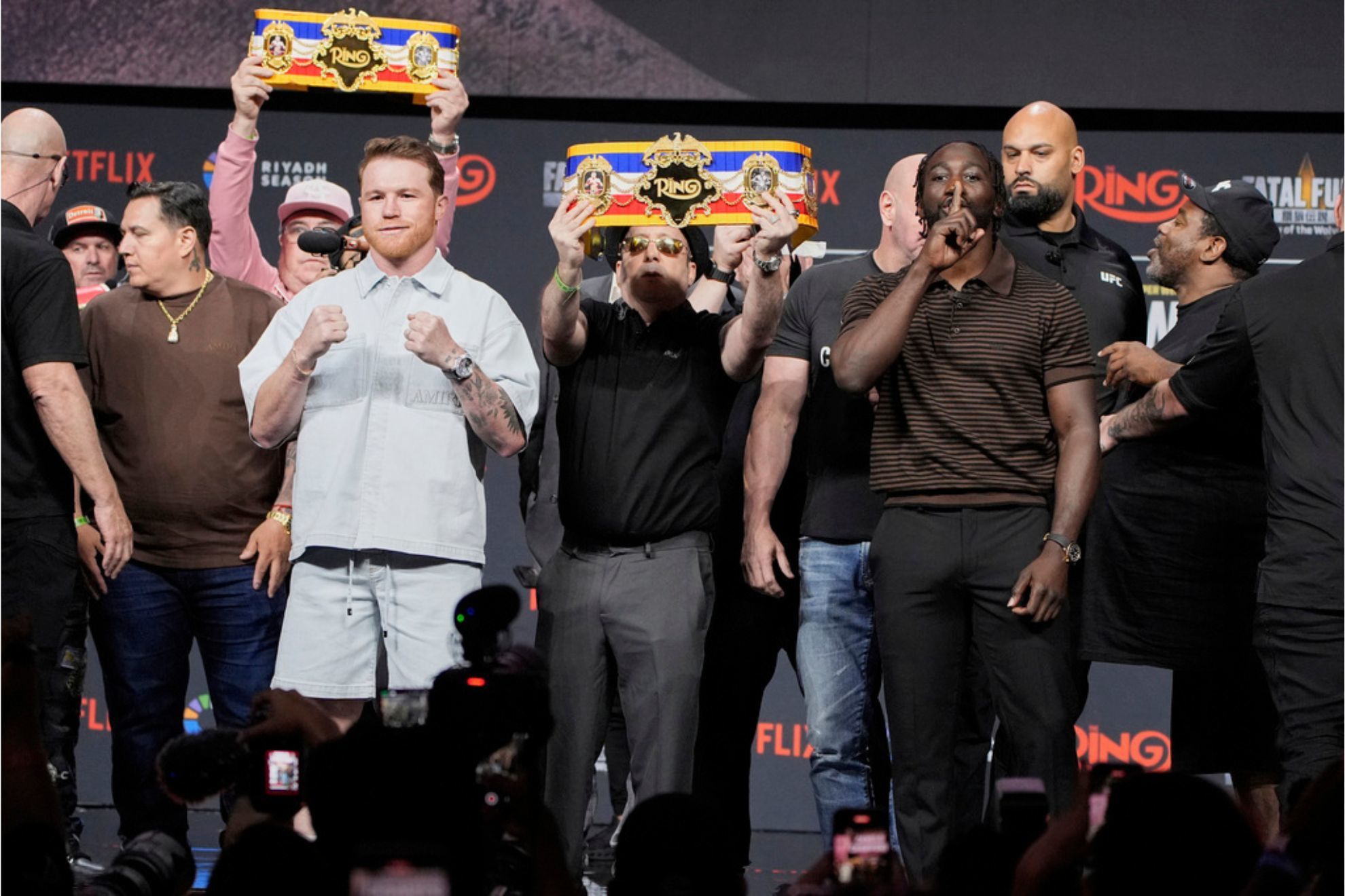 Canelo Alvarez, center left, and Terence Crawford pose during a news conference for their upcoming boxing match