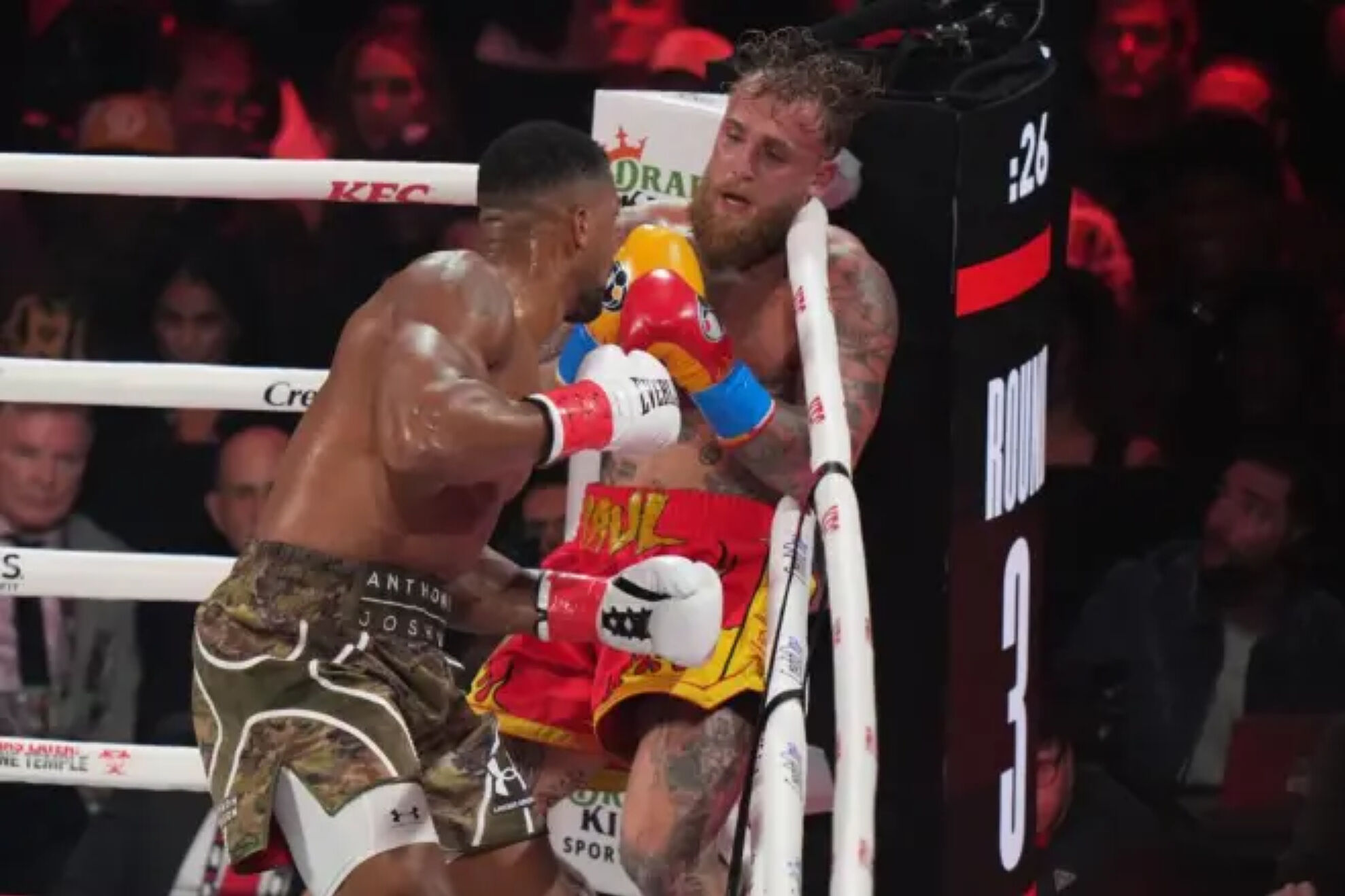 Anthony Joshua puts Jake Paul on the ropes.