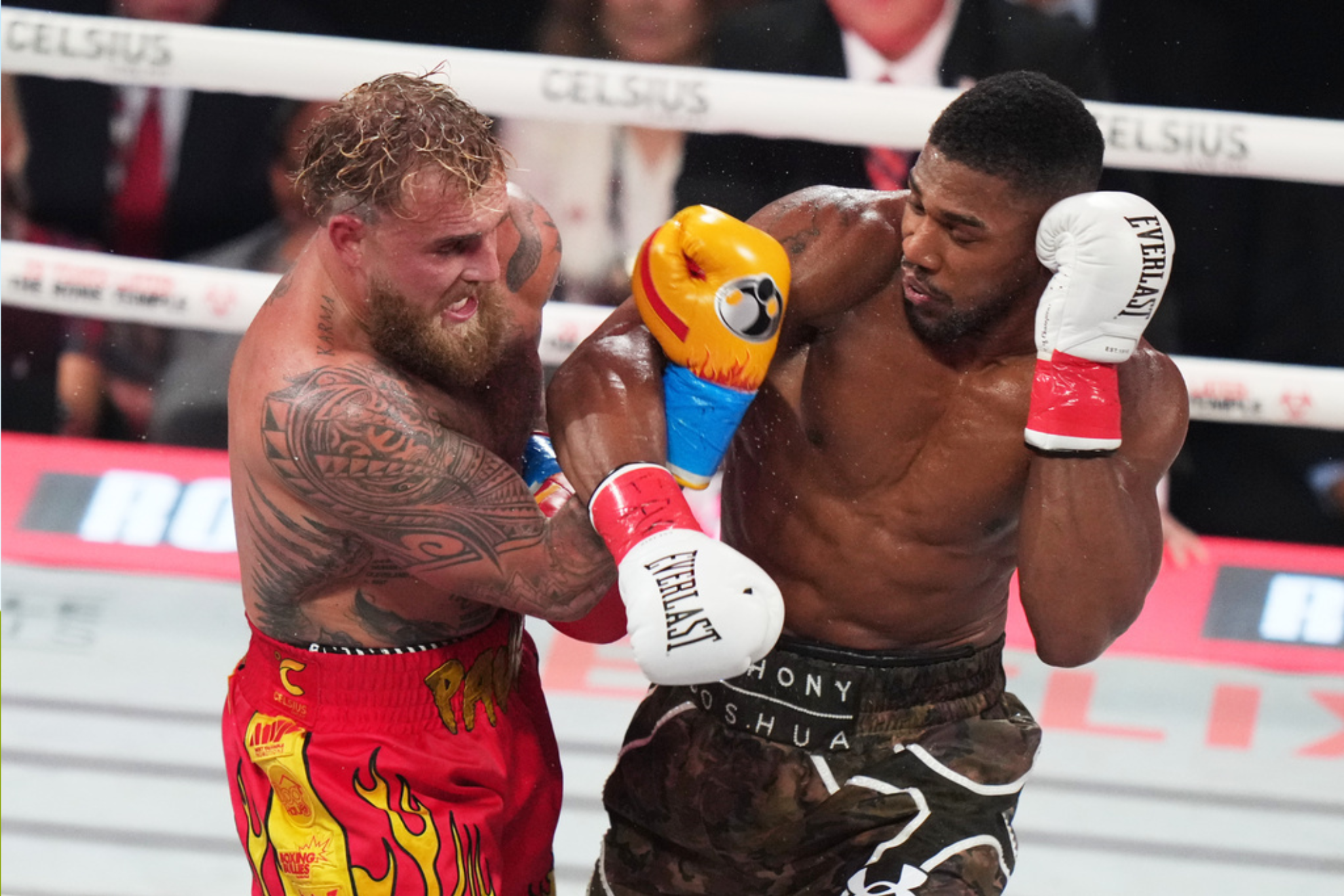 Jake Paul, left, and Anthony Joshua, right, compete during their heavyweight boxing match