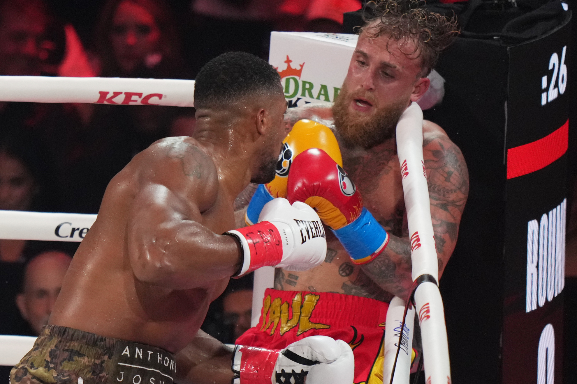 Anthony Joshua hunts down Jake Paul during their boxing match on December 19, 2025. Joshua won by knockout, and Paul suffered a broken jaw.