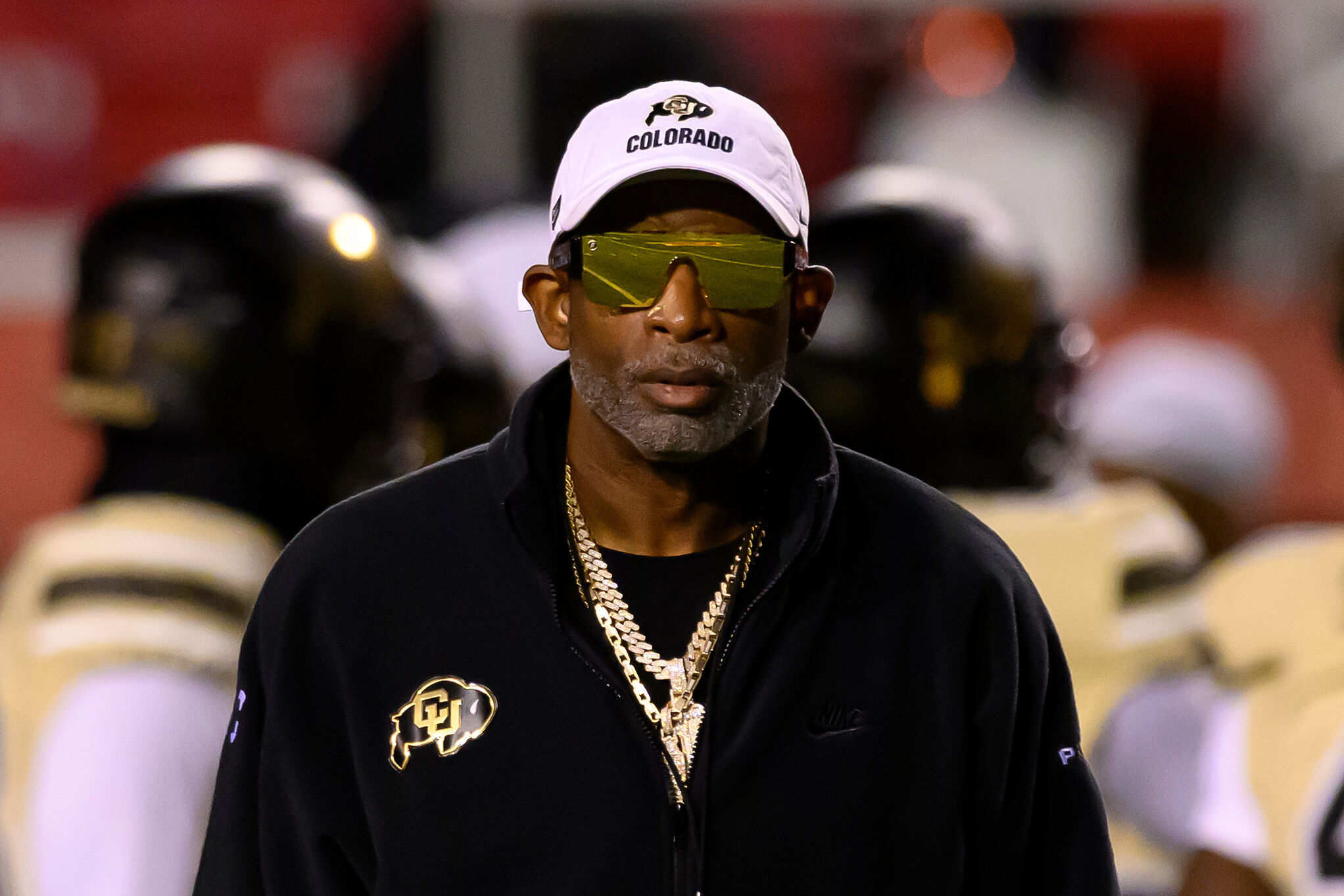 Colorado head coach Deion Sanders watches his players warm up before an NCAA college football game against Utah