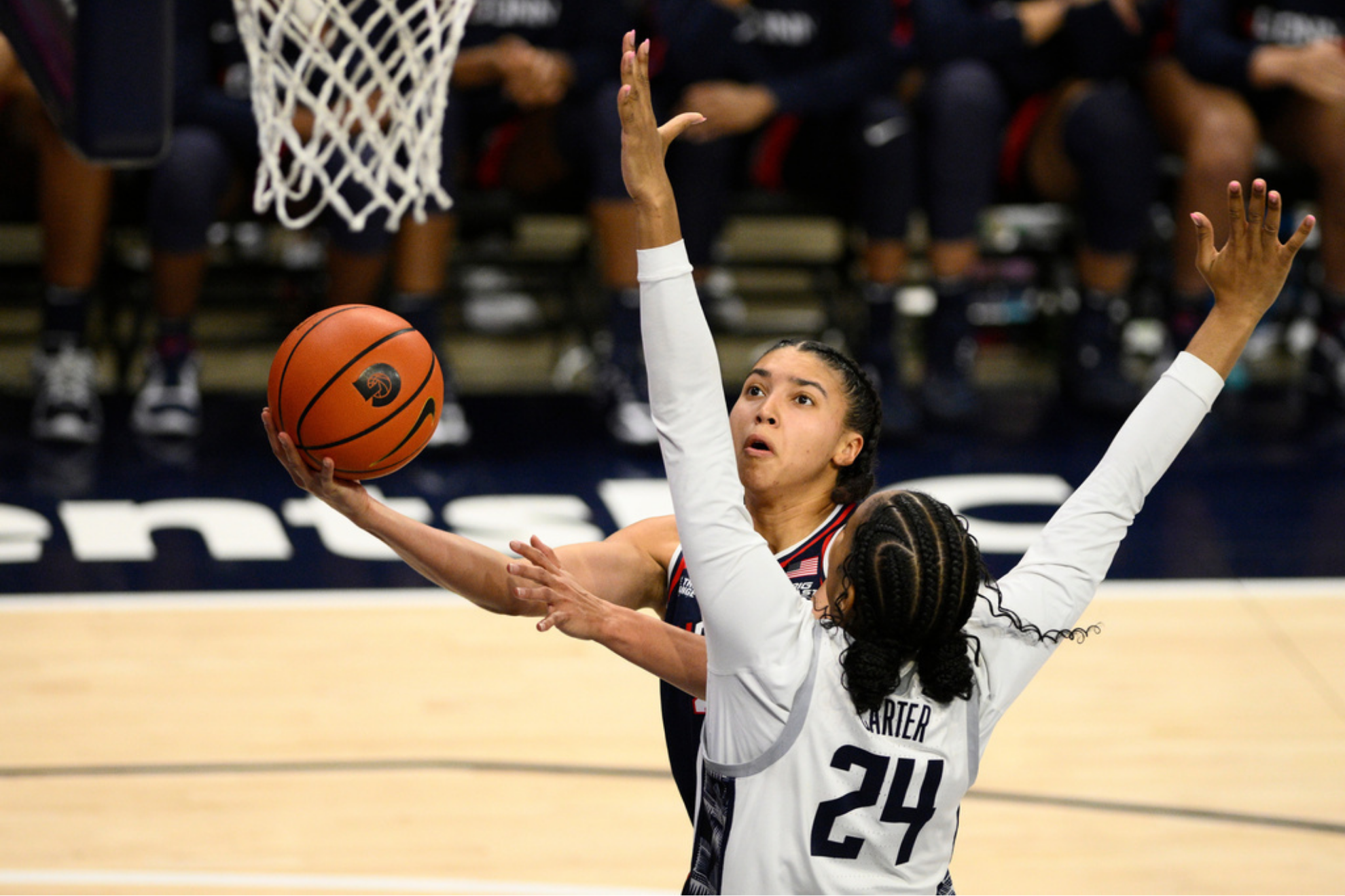 UConn guard Azzi Fudd, back, goes to the basket against Georgetown forward Cristen Carter
