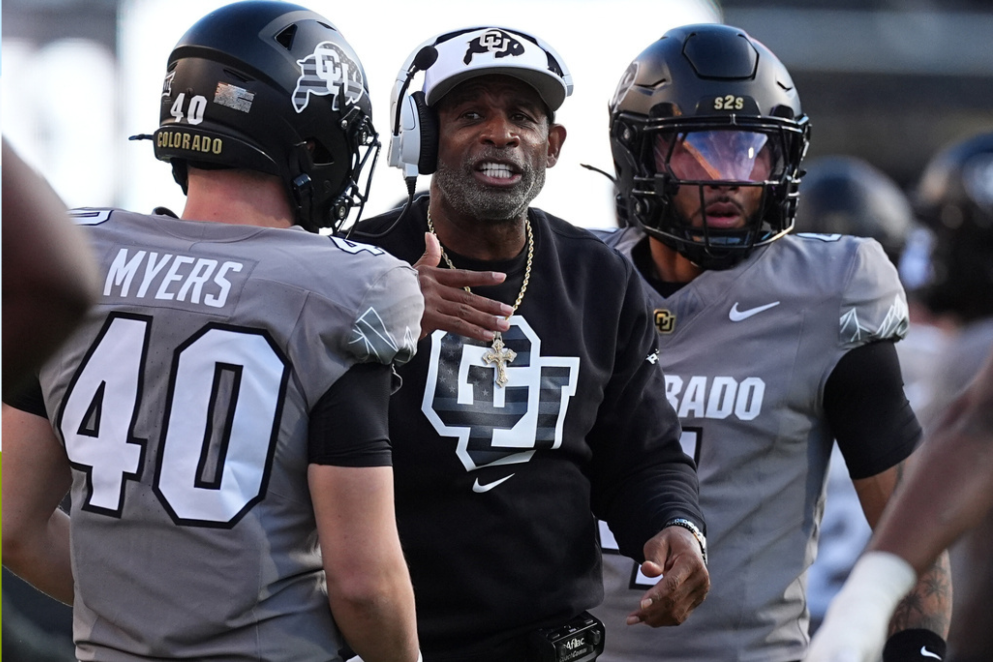 Colorado head coach Deion Sanders confers with linebacker Shaun Myers (40) in the first half of an NCAA college football game