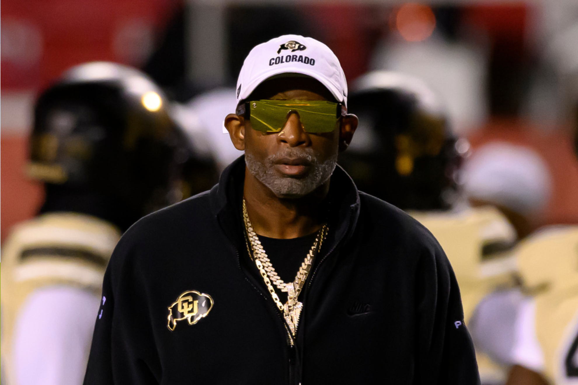 Colorado head coach Deion Sanders watches his players warm up before an NCAA college football game
