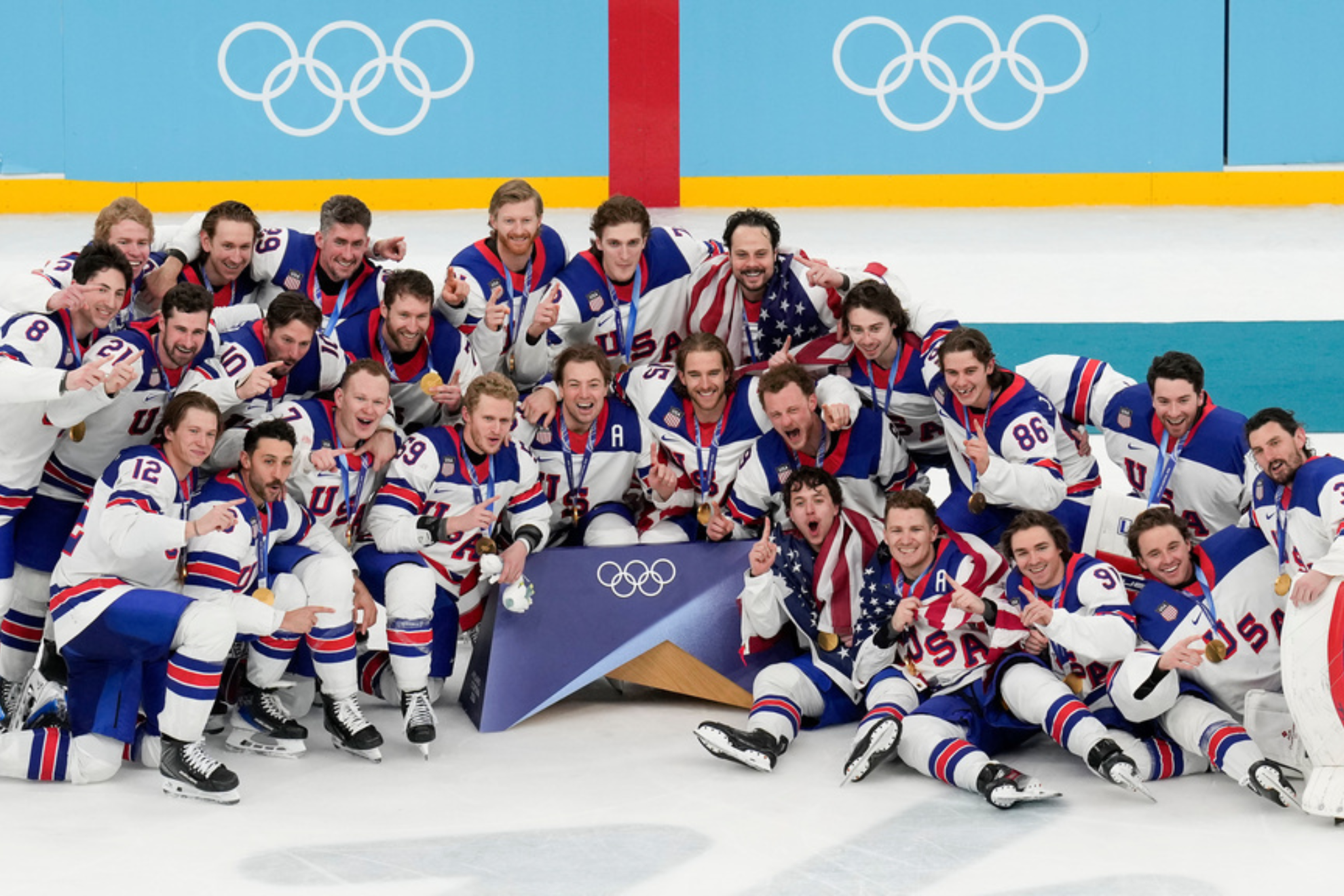 Team USA poses for a group photo after defeating Canada in the men's ice hockey gold medal game at the 2026 Winter Olympics