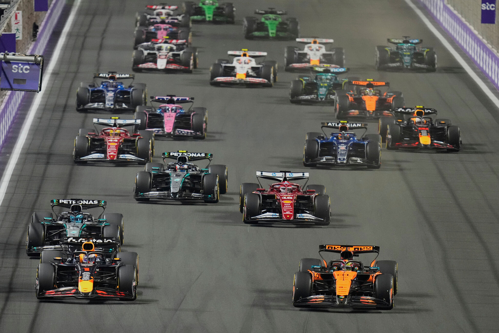 Red Bull driver Max Verstappen of the Netherlands, left, steers his car followed by McLaren driver Oscar Piastri of Australia during the Formula One Saudi Arabian Grand Prix