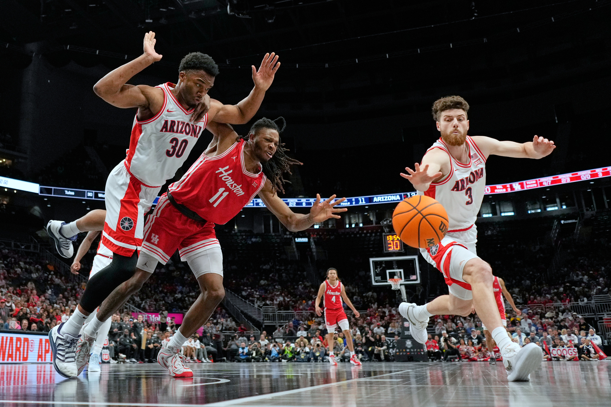 Houston's Joseph Tugler (11) chases a loose ball between Arizona's Tobe Awaka (30) and Anthony Dell'Orso (3) during the first half of an NCAA College Basketball game