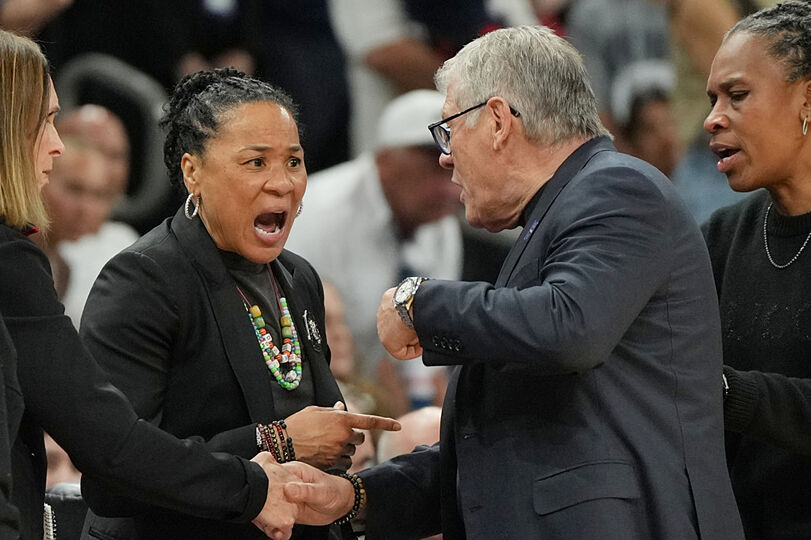 South Carolina head coach Dawn Staley exchanges words with UConn head coach Geno Auriemma after their final four contest.