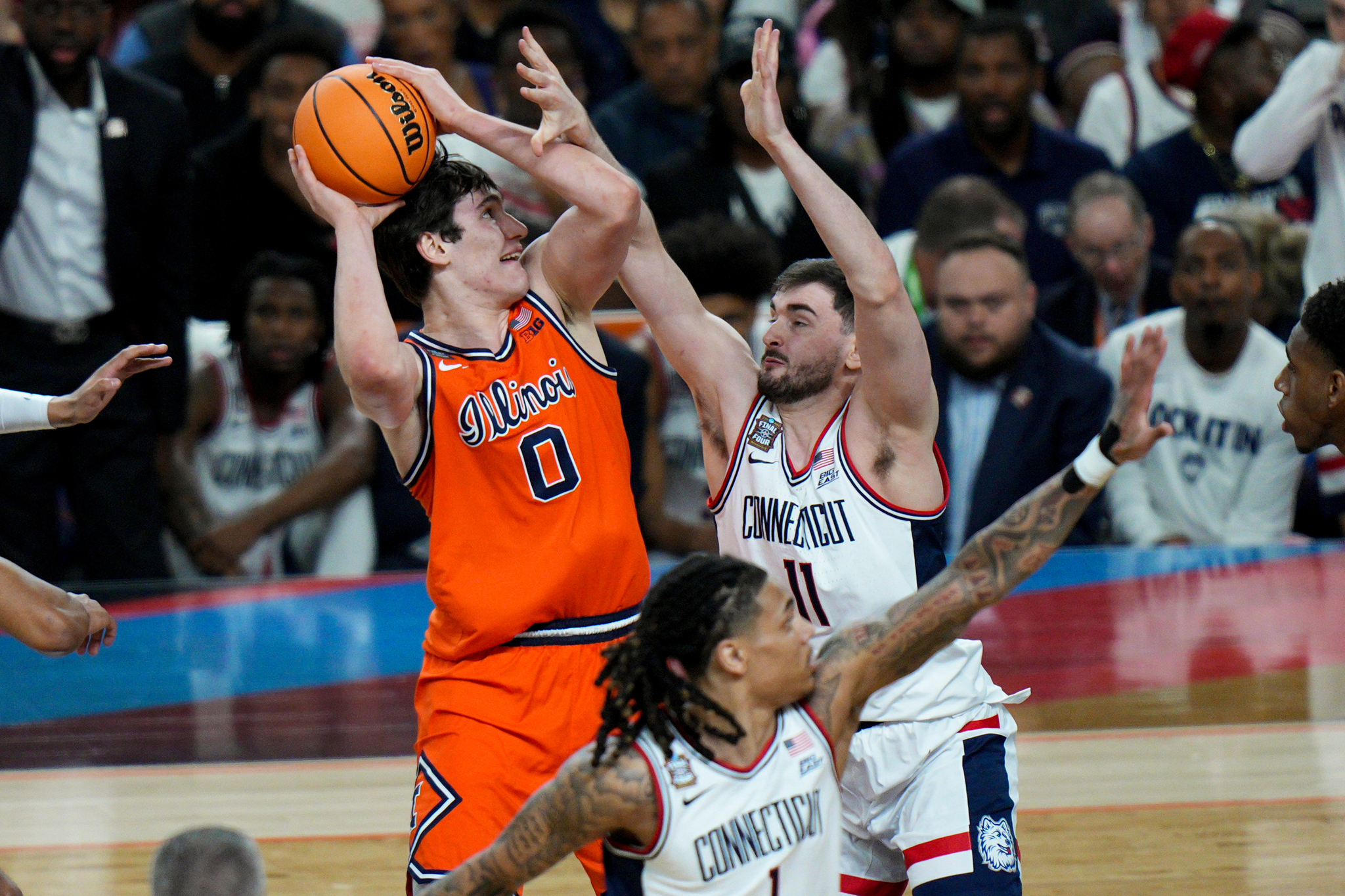 Illinois forward David Mirkovic (0) shoots over UConn forward Alex Karaban (11) during the first half of an NCAA college basketball tournament semifinal game