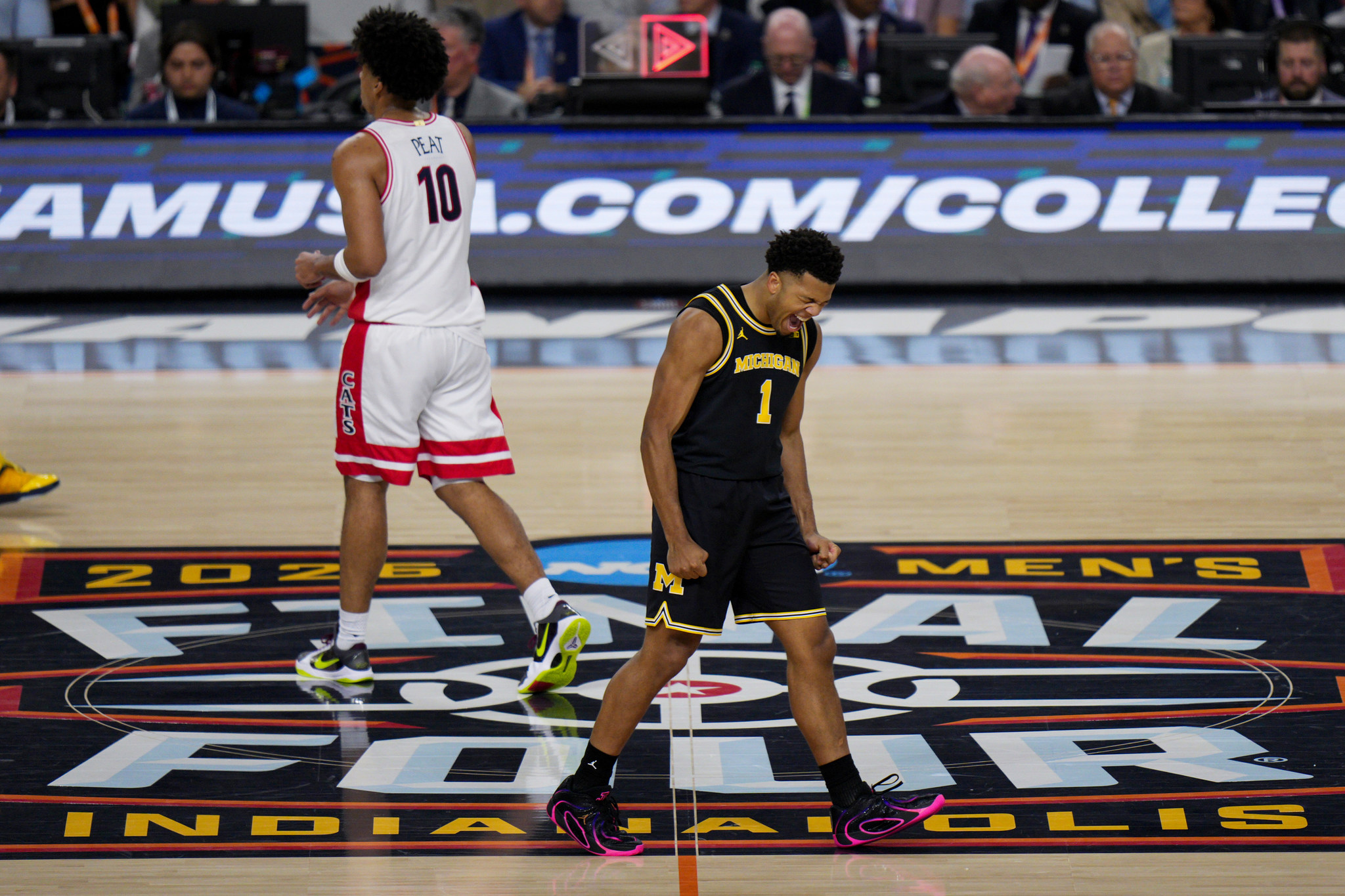Michigan guard Trey McKenney (1) celebrates his basket against Arizona during the first half of an NCAA college basketball tournament semifinal game