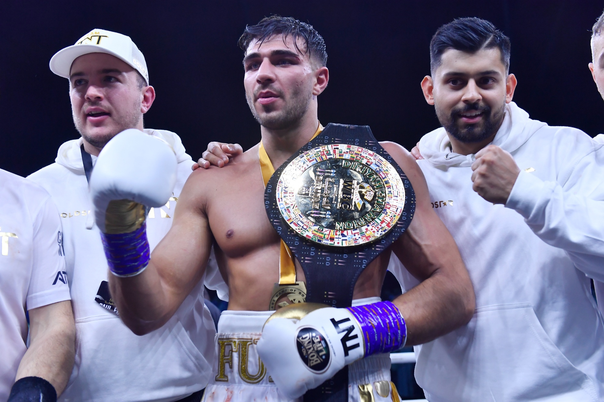 Tommy Fury, center, celebrates after defeating Jake Paul in a boxing match in Riyadh, Saudi Arabia, late Sunday, Feb. 26, 2023. (AP Photo)