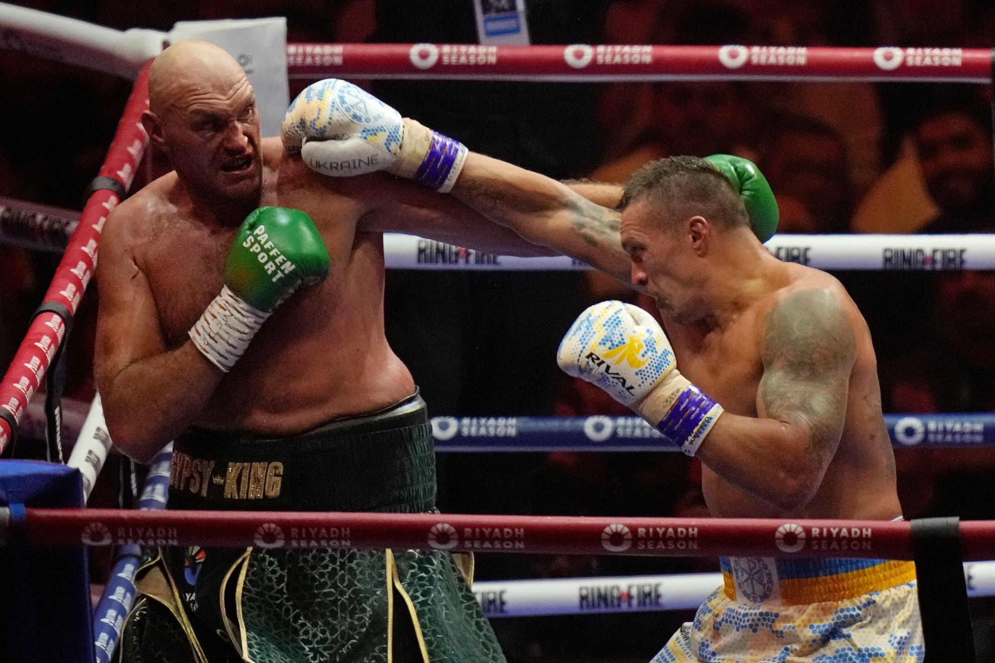 Britain's Tyson Fury, left, and Ukraine's Oleksandr Usyk trade blows during their undisputed heavyweight world championship boxing fight