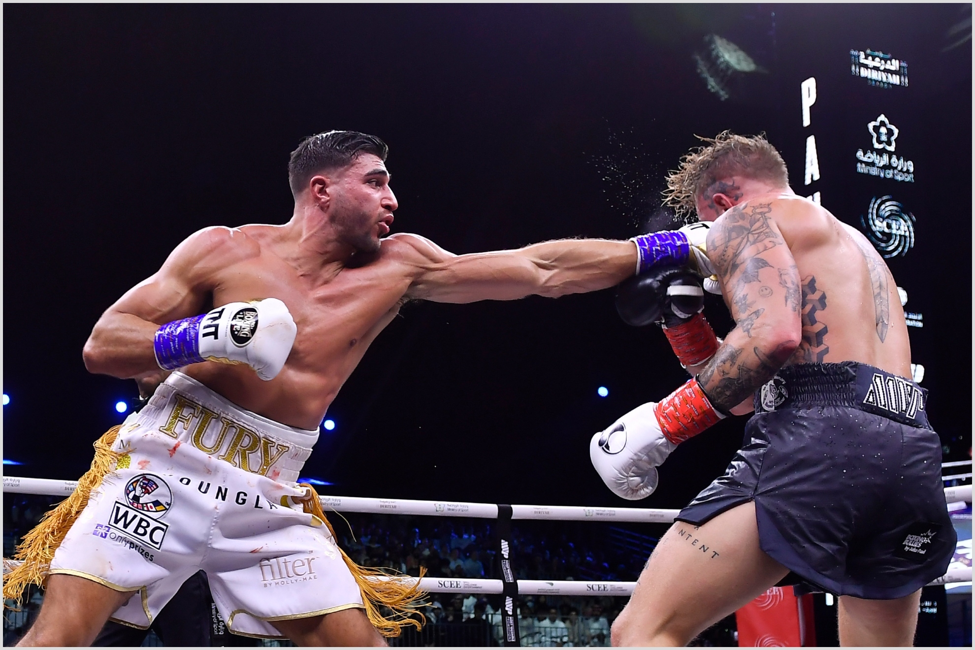 Jake Paul, right, and Tommy Fury, in action during their boxing match, in Riyadh, Saudi Arabia, early Monday, Feb. 27, 2023.