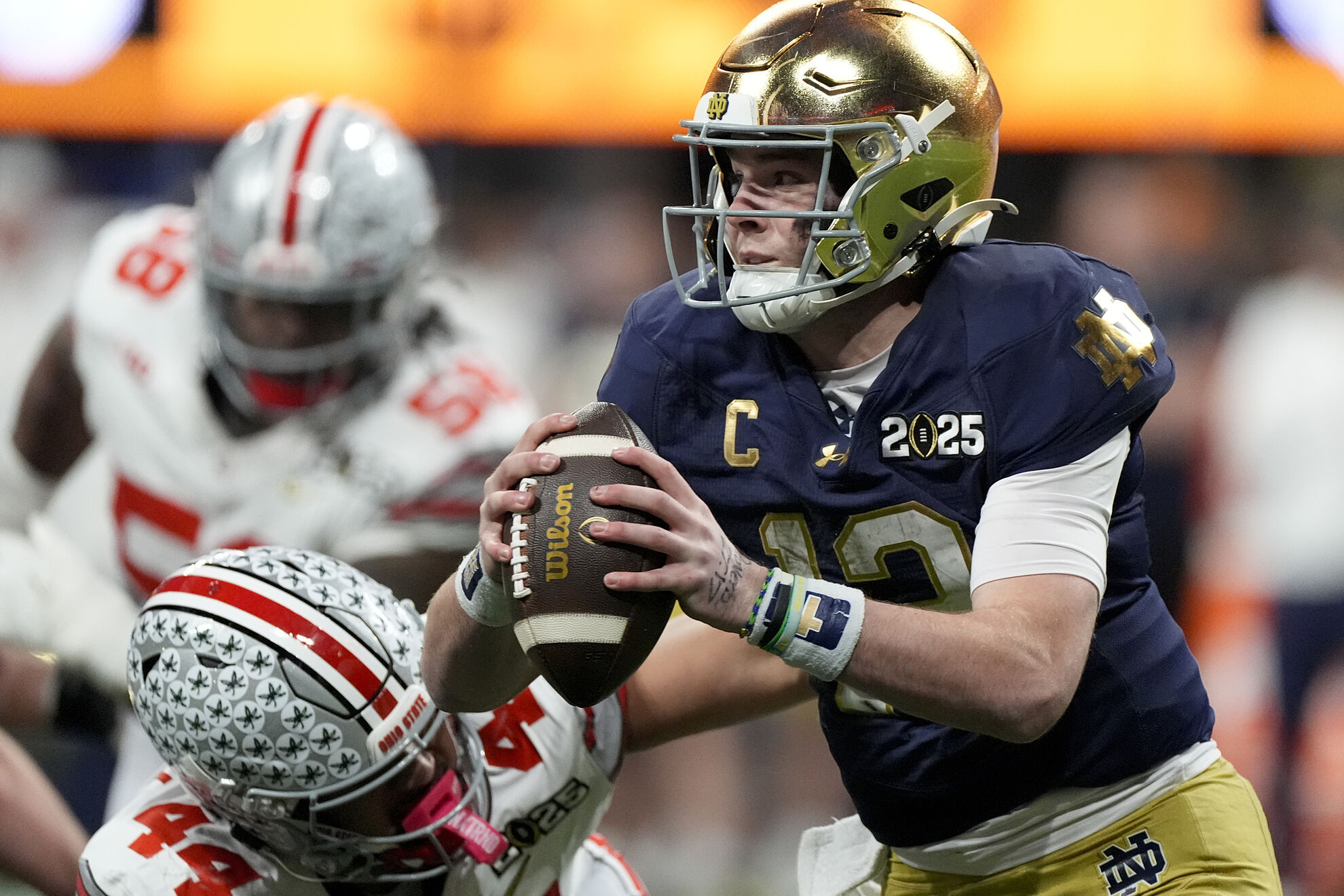Notre Dame quarterback Riley Leonard is tackled by Ohio State defensive end JT Tuimoloau during first half of the College Football Playoff national championship game Monday, Jan. 20, 2025, in Atlanta. (AP Photo/Brynn Anderson)