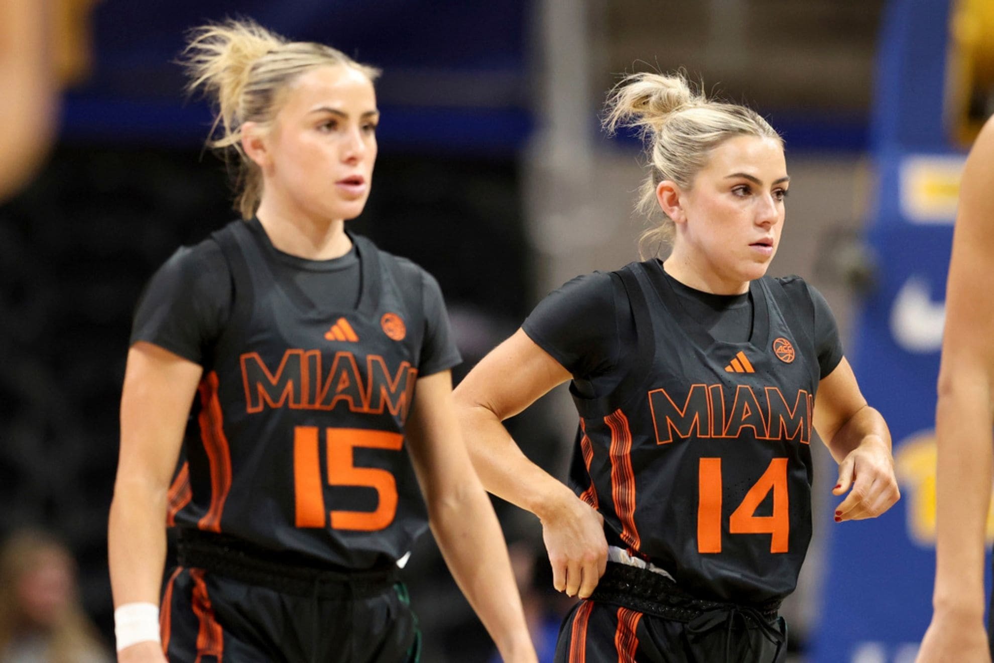 Miami's Hanna Cavinder (15), left, and Haley Cavinder (14) are seen against Pittsburgh during an NCAA basketball game on Sunday, Dec. 15, 2024, in Pittsburgh. (AP Photo/Gregory Payan)