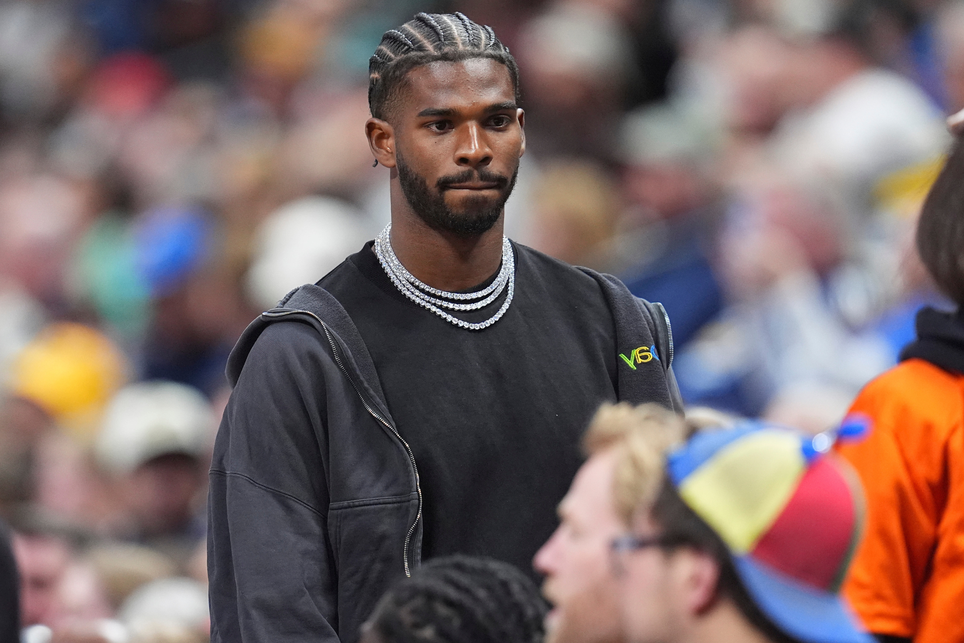 Shedeur Sanders sits courtside at a Portland Trail Blazers vs. Denver Nuggets game.