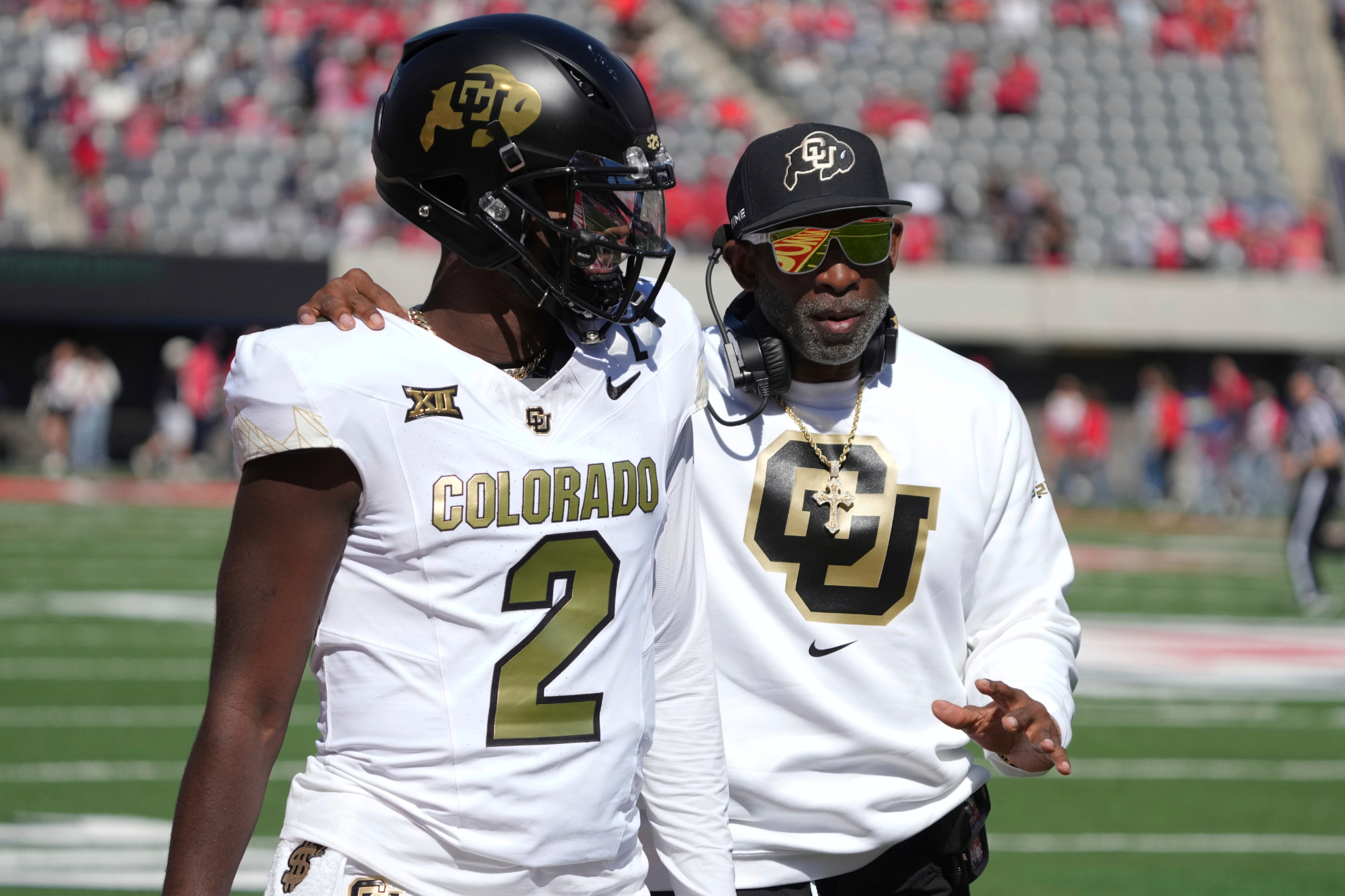 Shedeur and Deion Sanders speak during a Colorado vs. Arizona game in the 2024 NCAA football season.